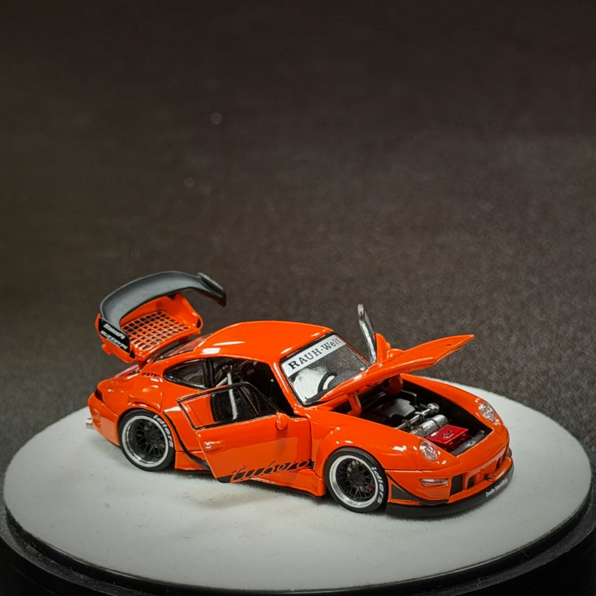 Lot57Supplies Diecast Shop PGM RWB 993 diecast model car in bright orange with opening doors, hood, and engine bay.