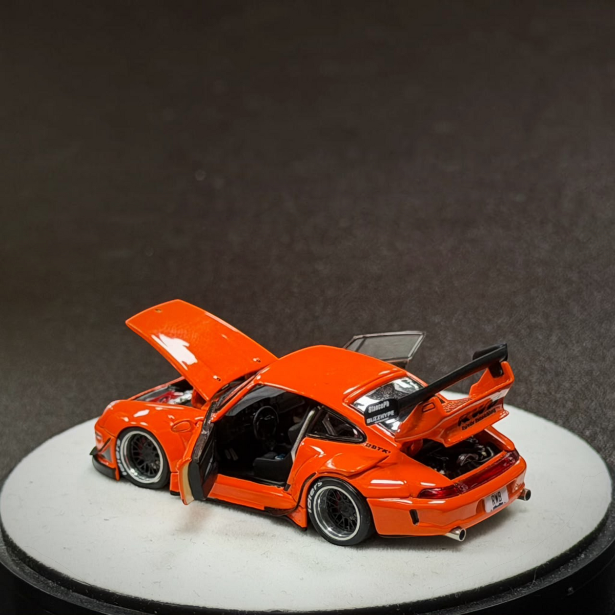 Lot57Supplies Diecast Shop PGM RWB 993 diecast model car in bright orange with open doors, hood, and engine bay