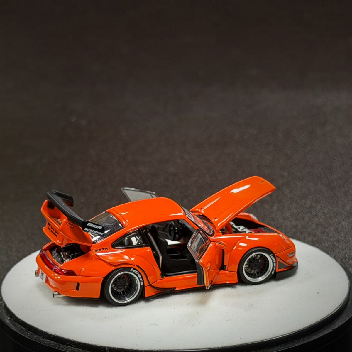 Lot57Supplies Diecast Shop PGM RWB 993 diecast model car in bright orange with opening doors, hood, and engine cover