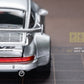 Lot57Supplies Diecast Shop PGM RWB930 silver diecast model car rear view with wide body kit and spoiler