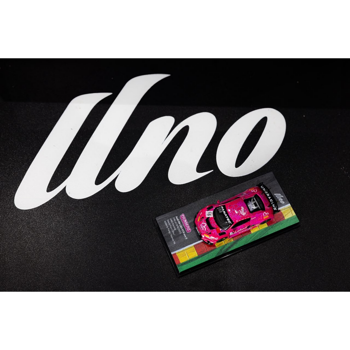 Lot57Supplies Diecast Shop 1:64 scale pink Audi R8 LMS GT3 EVO II diecast model car on a display base