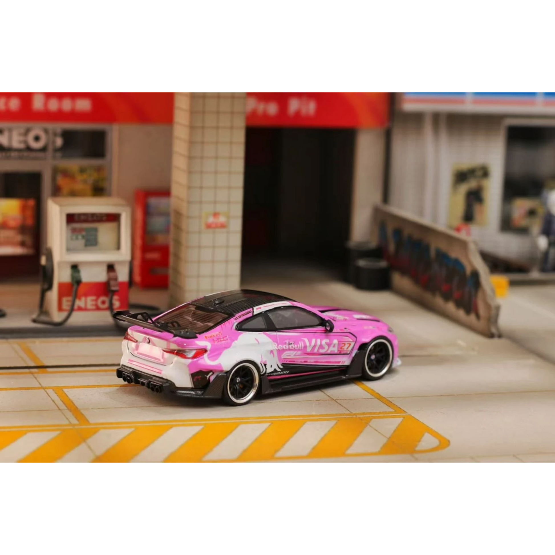 Lot57Supplies Diecast Shop 1:64 scale SW G82 M4 diecast car in pink Bull livery parked in a miniature garage setting.