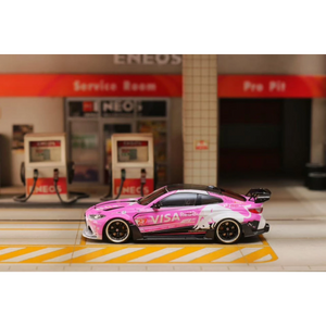 Lot57Supplies Diecast Shop 1:64 scale SW G82 M4 diecast car in pink Bull livery parked at a miniature gas station