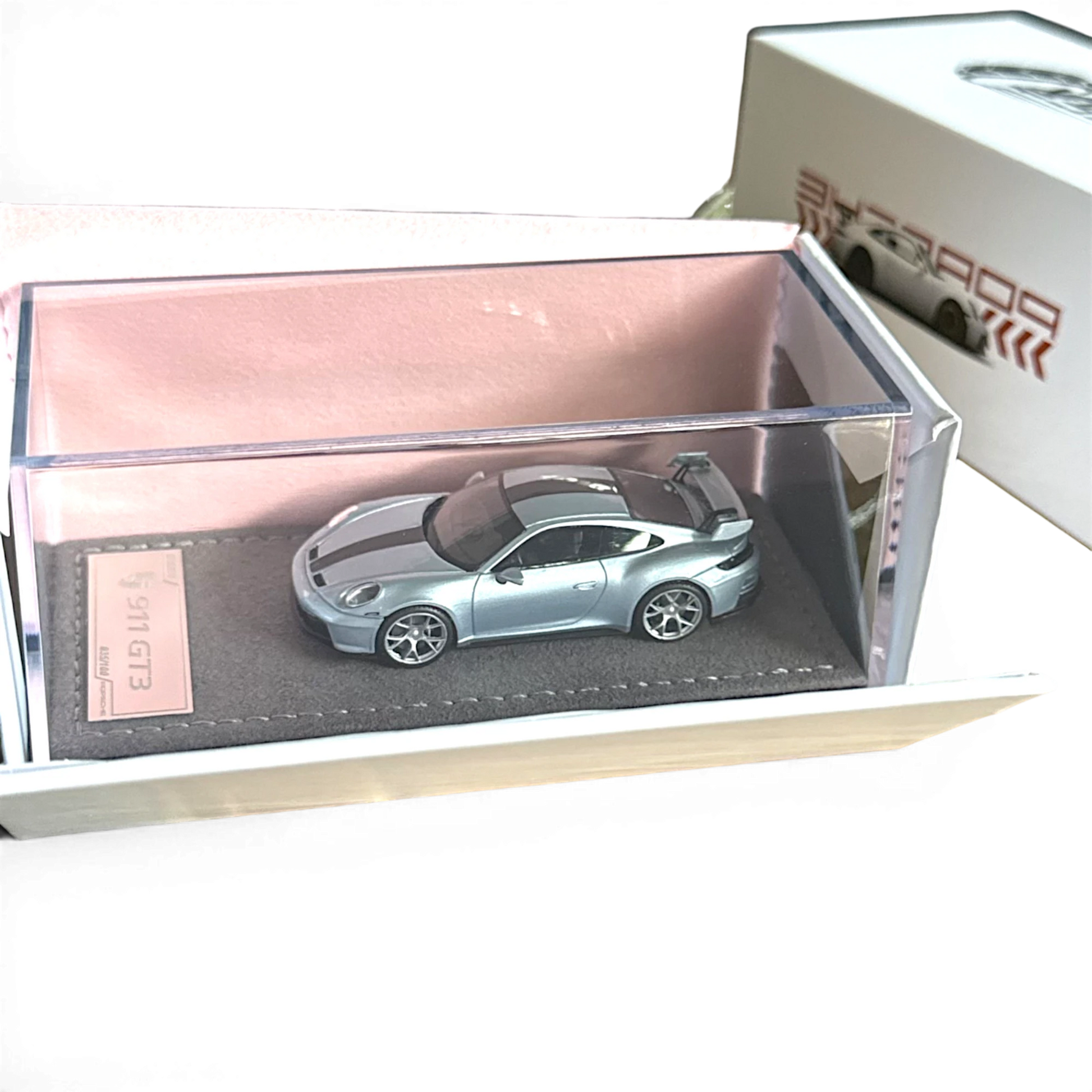 Lot57Supplies Diecast Shop ZJWJ 1:64 scale ice blue Porsche 911 GT3 resin model car on a velvet base in acrylic case