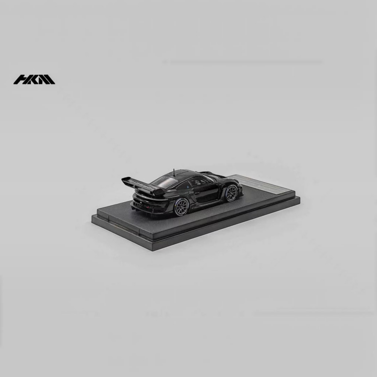 Lot57Supplies Diecast Shop HKM Porsche 911 992 GT3 R Rennsport diecast model car in gloss black on display stand