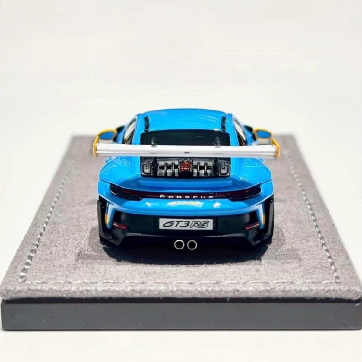 Lot57Supplies Diecast Shop 1:64 scale HH Model Porsche 992.1 GT3 RS in Riviera Blue, rear view on display base.