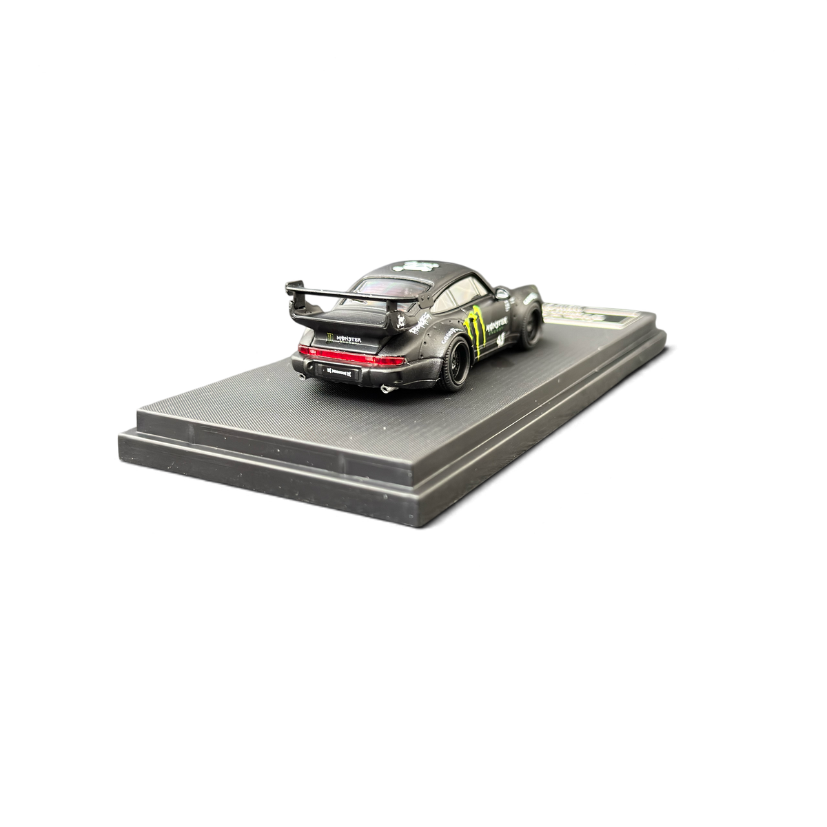 Lot57Supplies Diecast Shop Mini Station Porsche RWB 964 diecast car in black with Monster Energy livery on display base