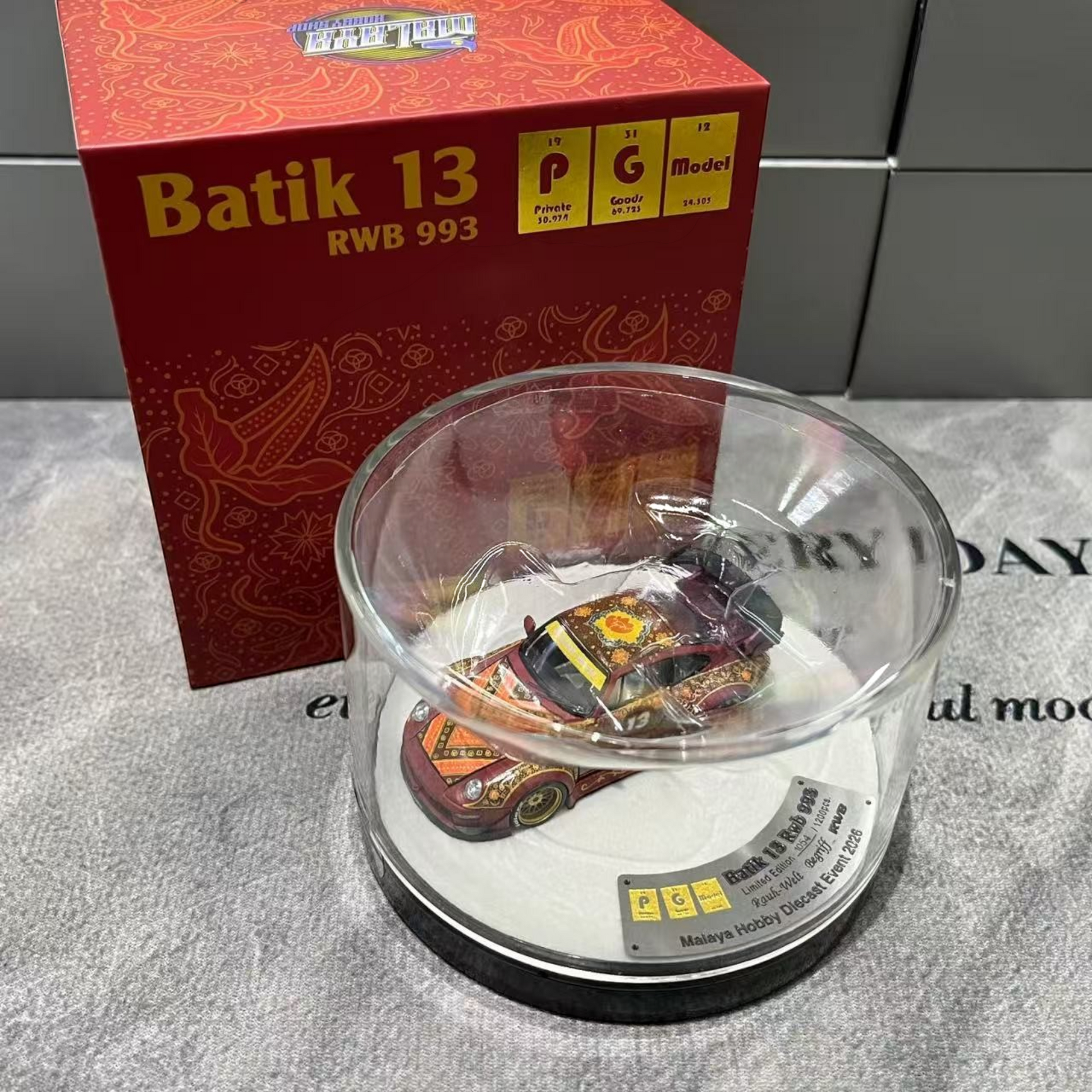 Lot57Supplies Diecast Shop PGM Porsche RWB 993 Batik 13 diecast car in red with gold alloys in a display case