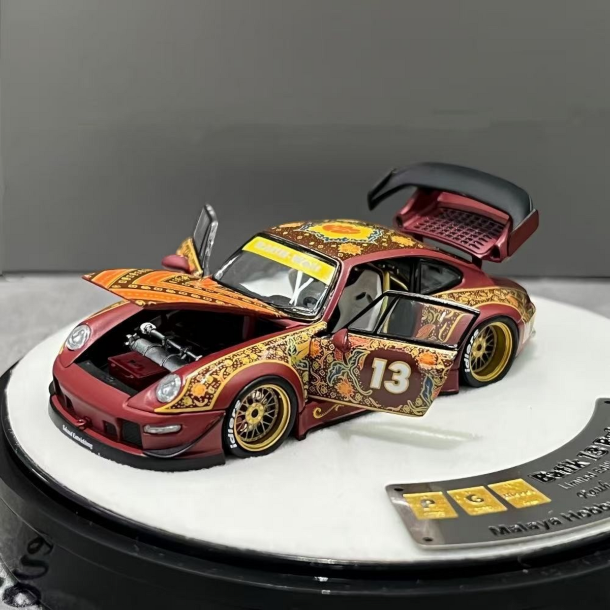 Lot57Supplies Diecast Shop PGM Porsche RWB 993 Batik 13 diecast model car in red with gold alloys and intricate patterns