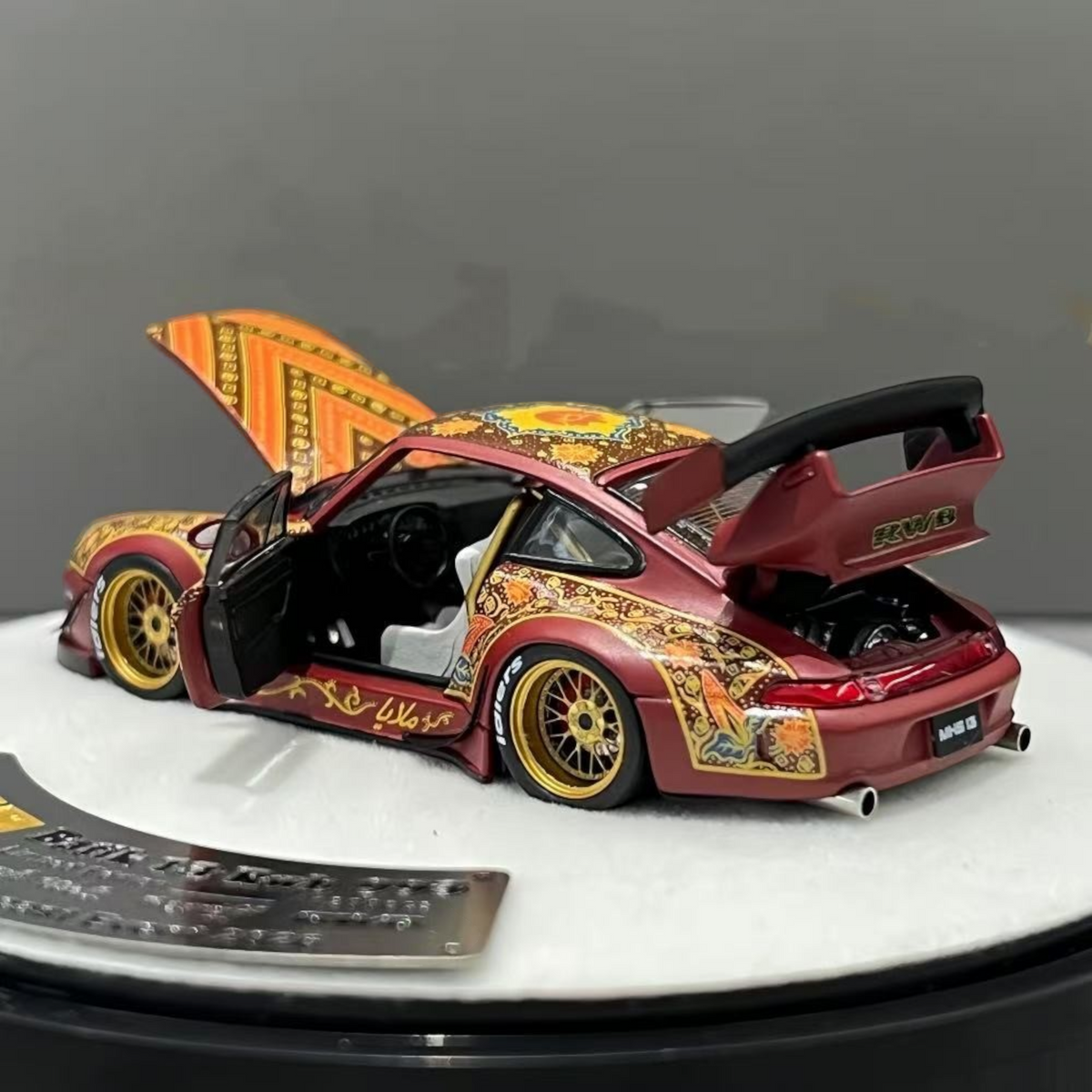 Lot57Supplies Diecast Shop PGM Porsche RWB 993 Batik 13 diecast model in red with gold alloys and intricate patterns