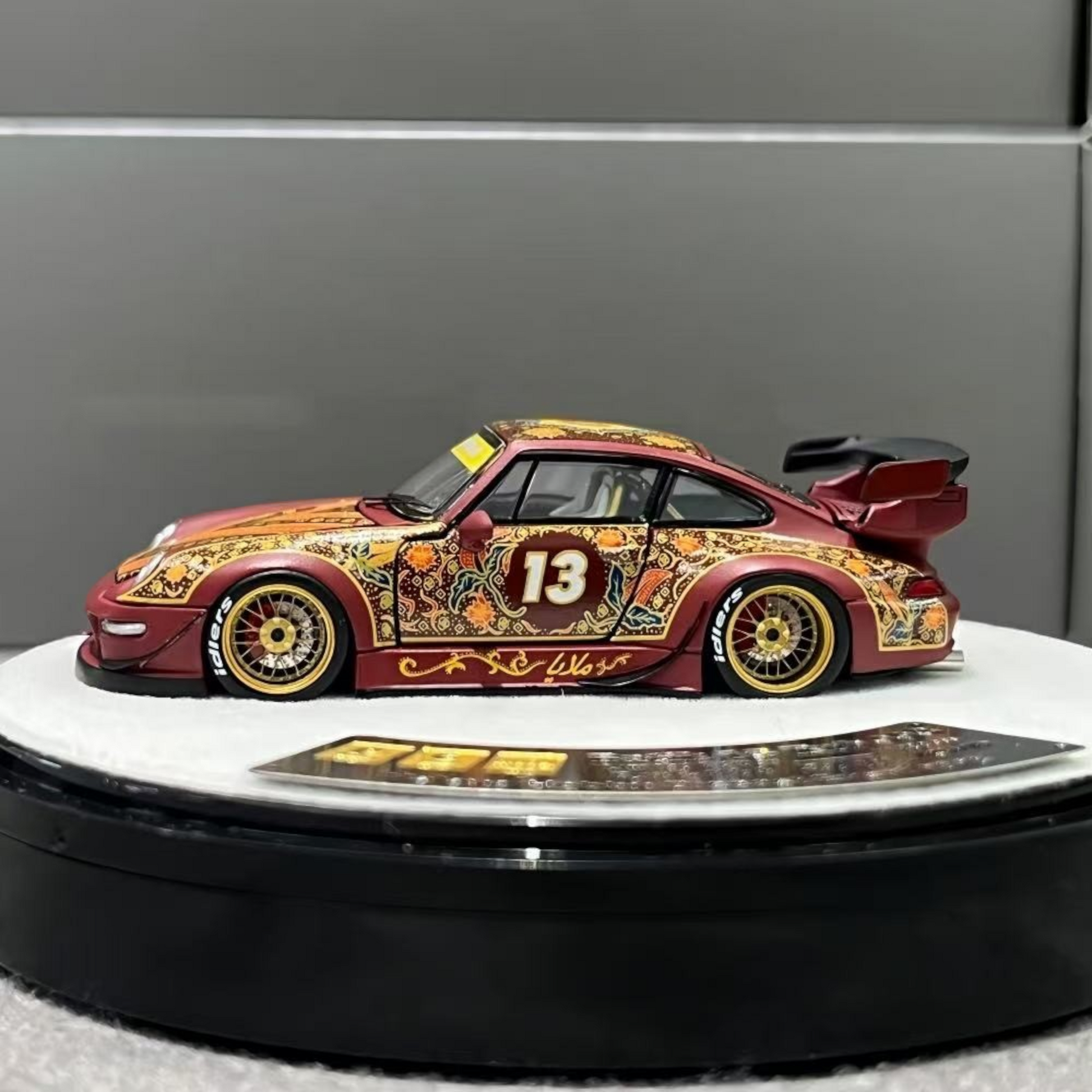 Lot57Supplies Diecast Shop PGM Porsche RWB 993 Batik 13 diecast car in red with gold alloys and intricate patterns