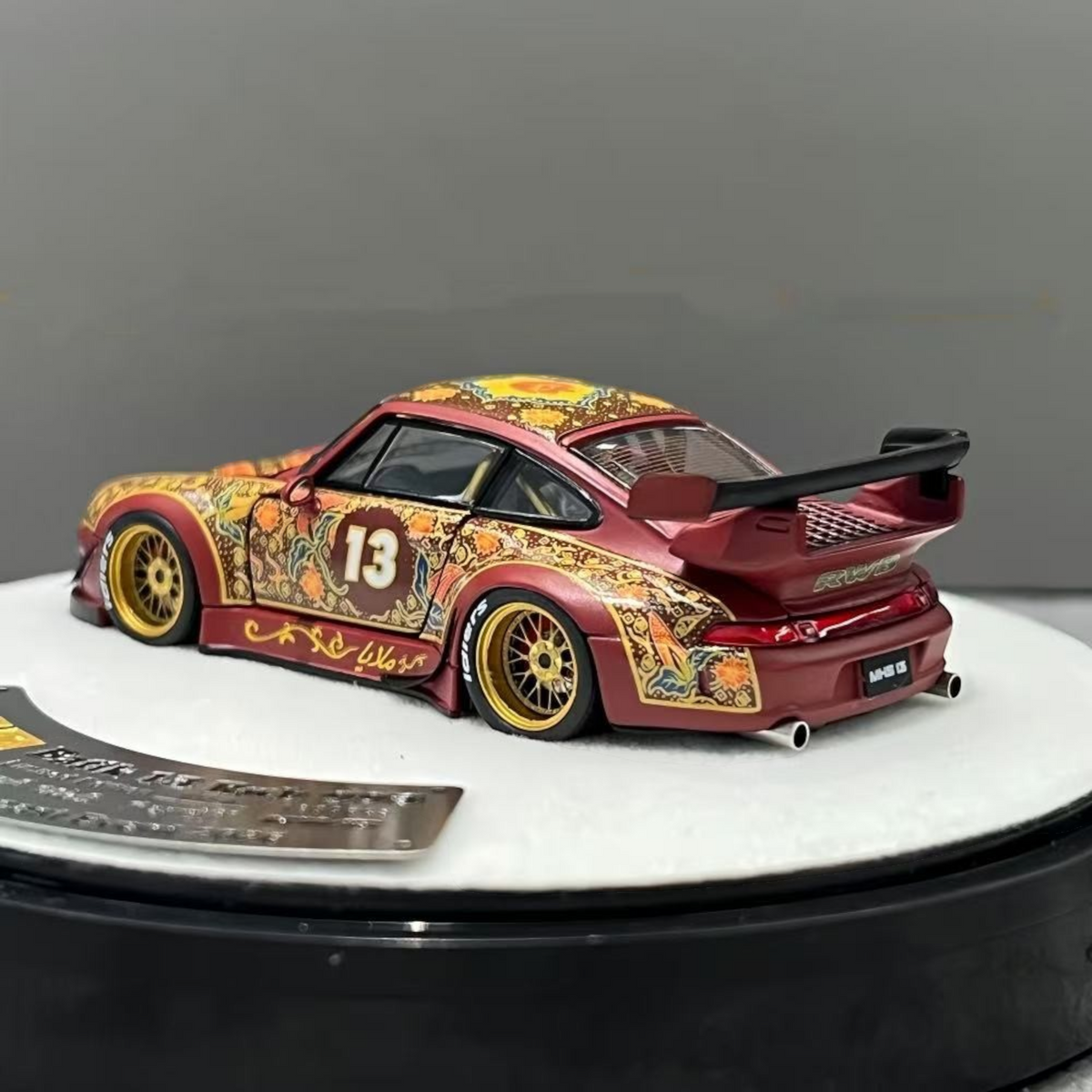 Lot57Supplies Diecast Shop PGM Porsche RWB 993 Batik 13 diecast car in red with gold alloys and intricate patterns