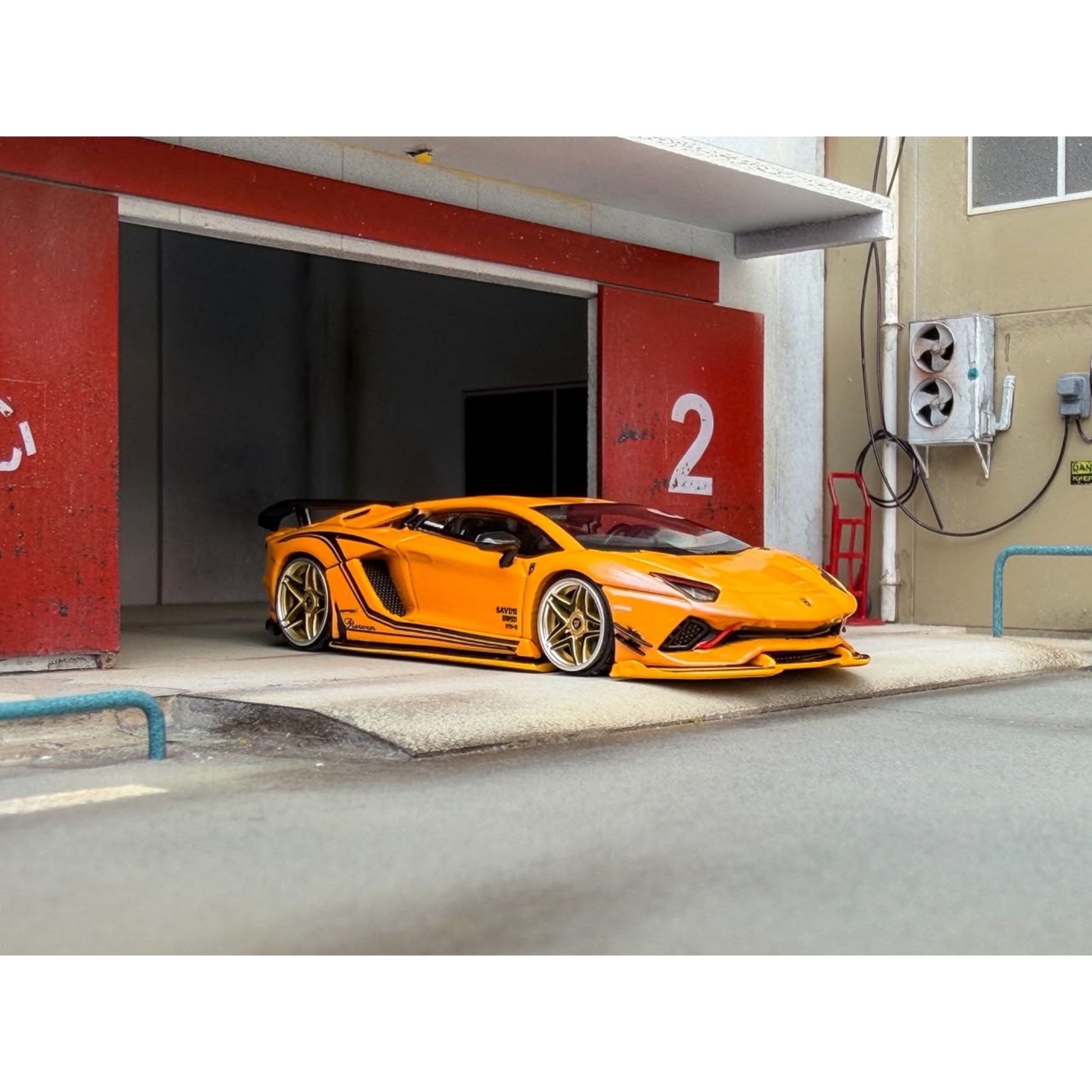 Lot57Supplies Diecast Shop Rotating Wheel Rowen Aventador S diecast model car in iridescent yellow parked in a garage