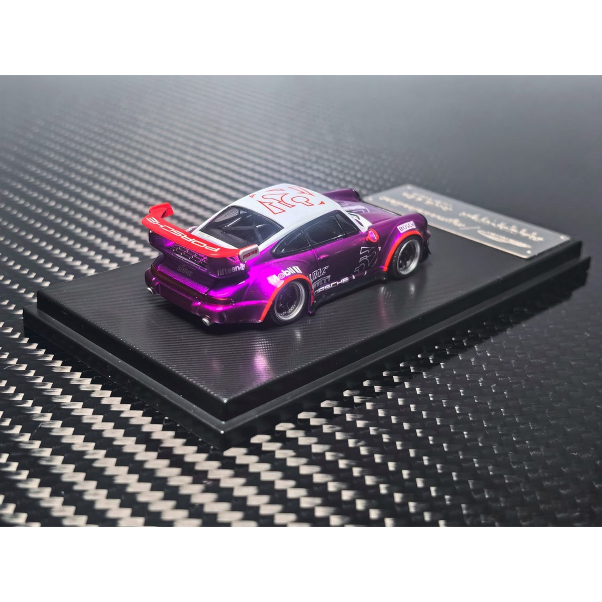 Lot57Supplies Diecast Shop MC RWB964 high wing diecast model car in transparent pink purple on a display base