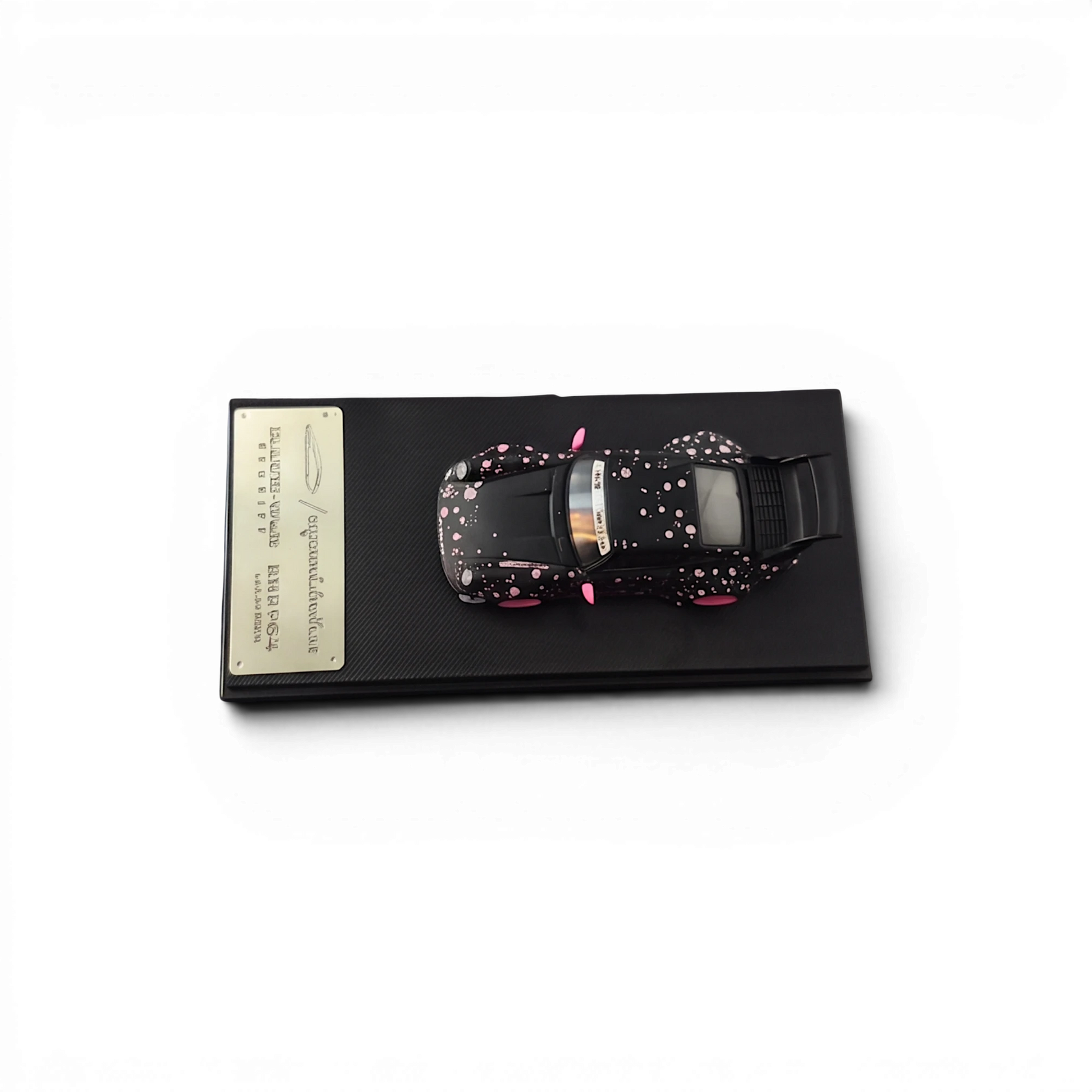 Lot57Supplies Diecast Shop MC RWB964 high wing diecast model car in black with pink sakura livery on display base