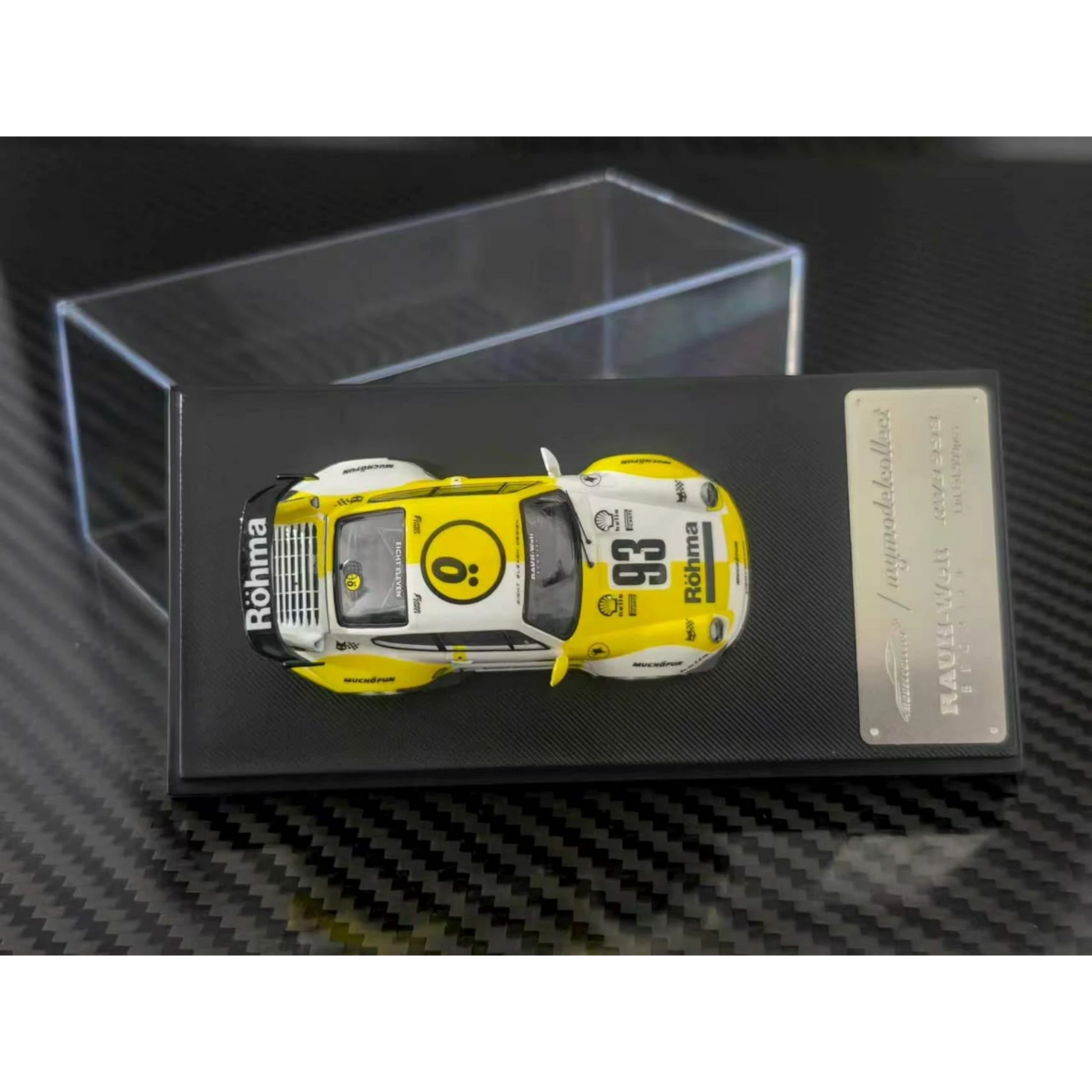 Lot57Supplies Diecast Shop 1:64 scale MC RWB993 High Wing diecast car in white and yellow Rohma livery on display base