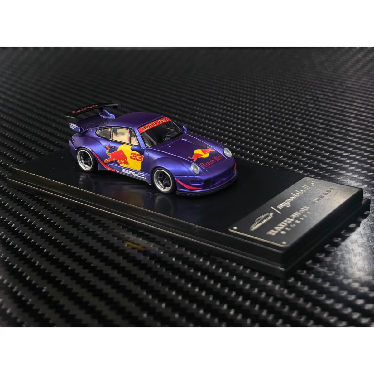 Lot57Supplies Diecast Shop MC RWB993 high wing diecast model car in matte purple with Red Bull livery in 1:64 scale.