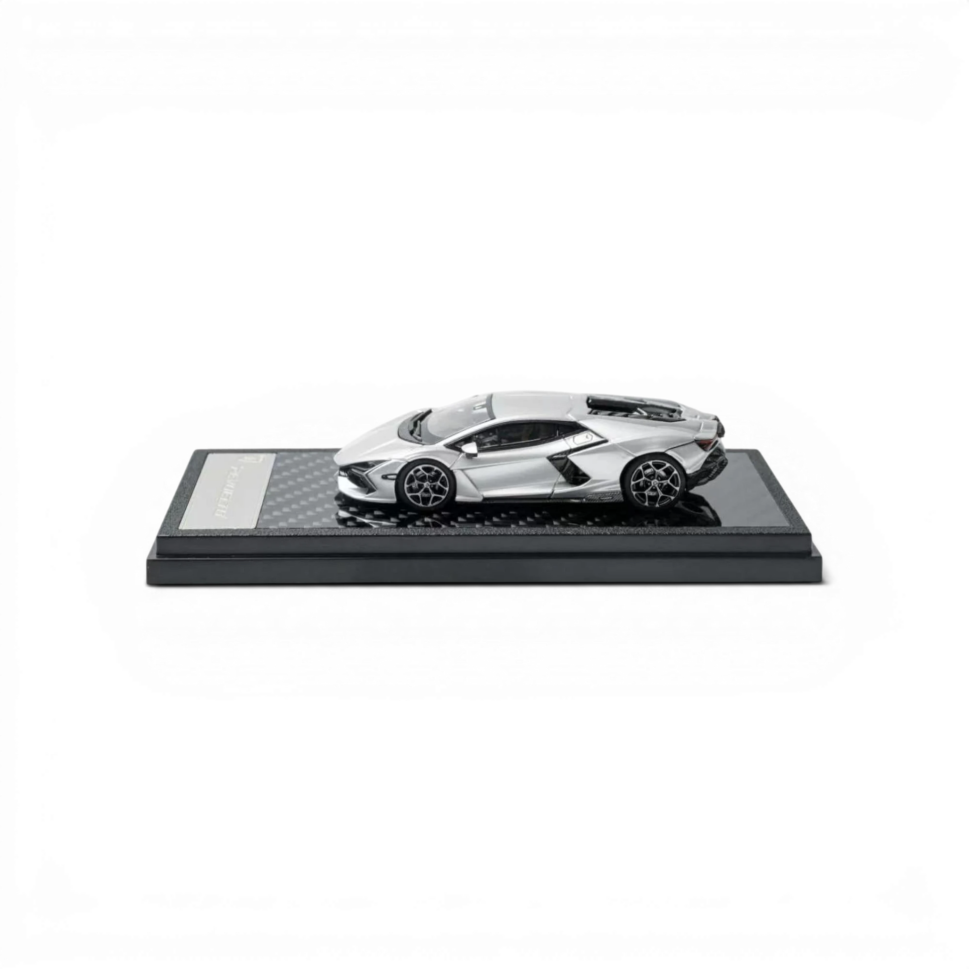 Lot57Supplies Diecast Shop 1:64 scale silver Lamborghini Revuelto diecast model car on a carbon fiber display base