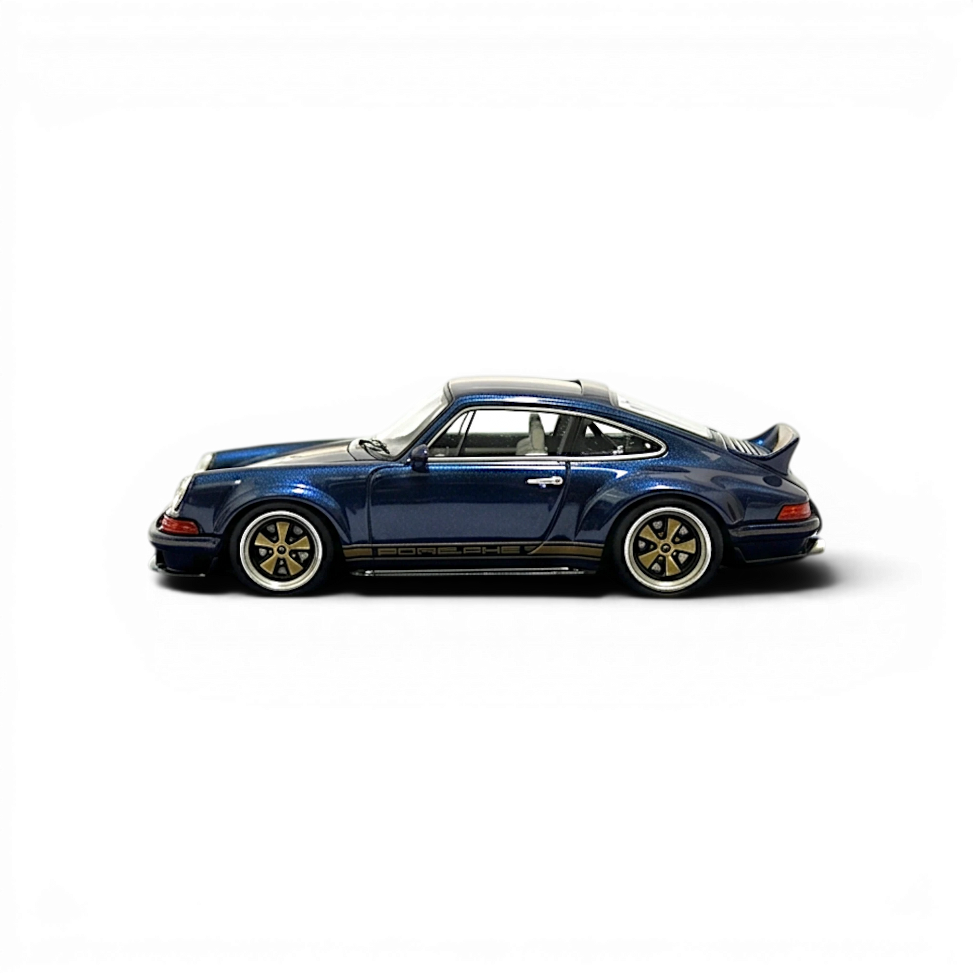 Lot57Supplies Diecast Shop 1:64 scale dark blue metallic gold Singer DLS resin model car with Porsche side stripe and gold wheels.