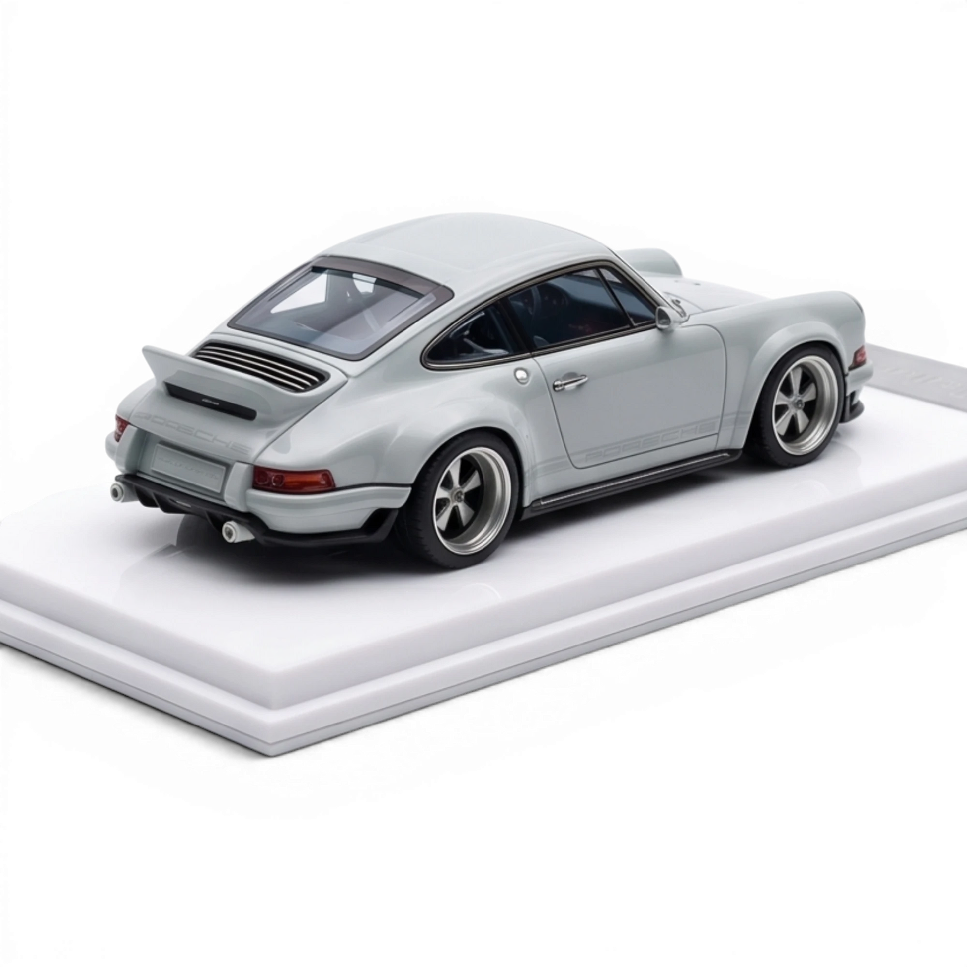 Lot57Supplies Diecast Shop 1:64 scale grey resin model of a Singer DLS Porsche with a rear spoiler and silver wheels on a white display base.