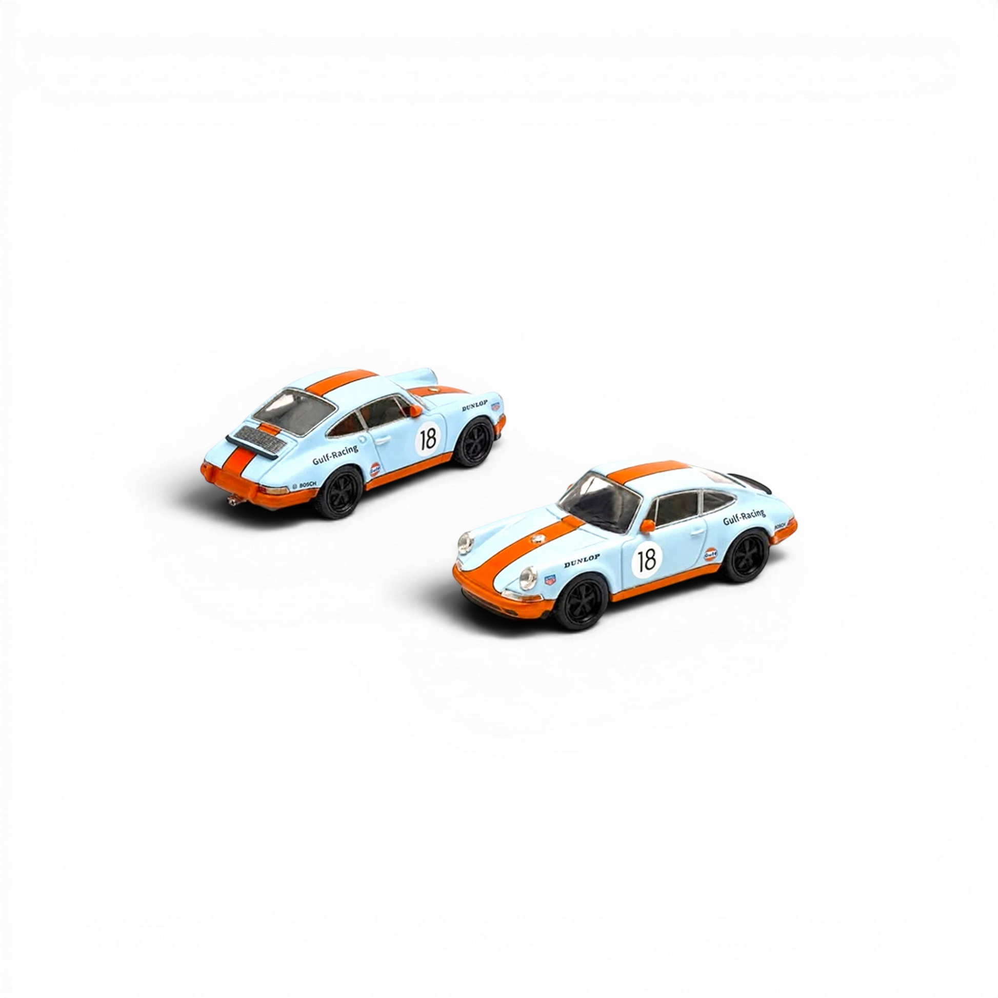 Two Lot57Supplies Diecast Shop Pop Race Singer Racing #18 diecast cars in orange and blue Gulf livery, 1:64 scale.