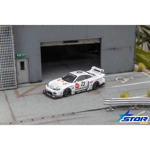 Lot57Supplies Diecast Shop 1:64 scale white Star Models S15 Silvia widebody diecast car with 23 livery in a garage