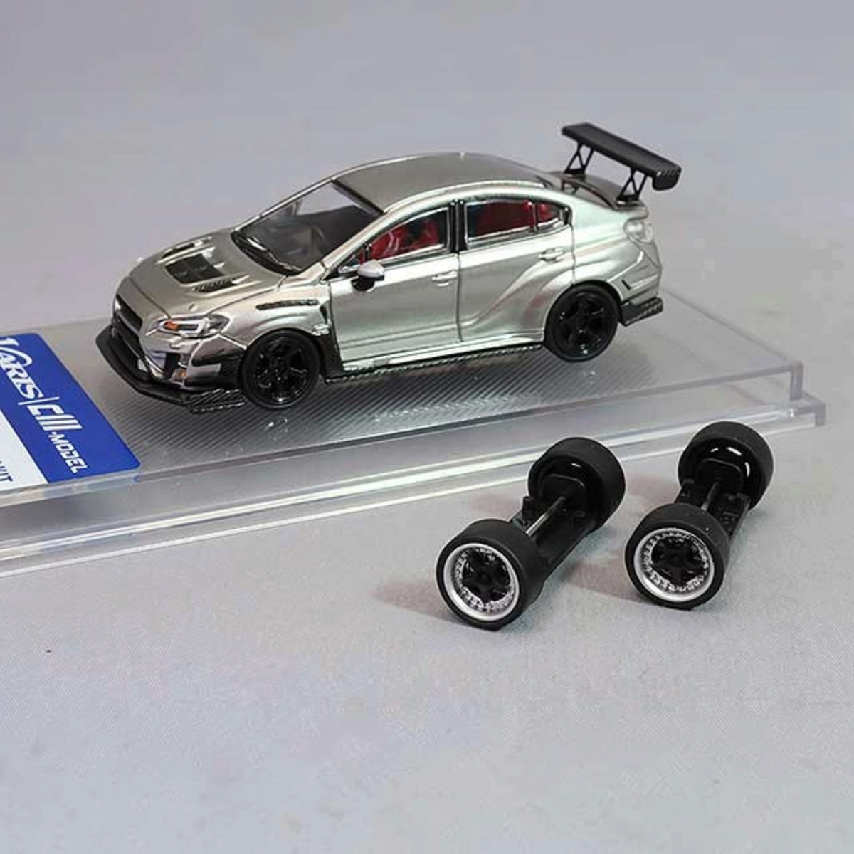 Lot57Supplies Diecast Shop silver CM Model Subaru WRX Varis widebody 1:64 diecast car with extra snap-on wheels