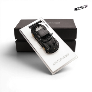 Lot57Supplies Diecast Shop SUHE 1:64 scale matte black Porsche 911 GT3 RS resin model car on a display base.