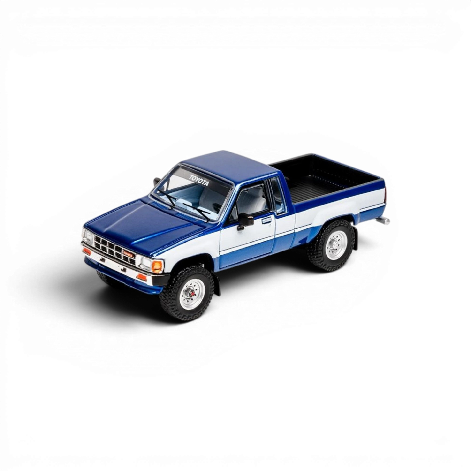 Lot57Supplies Diecast Shop 1:64 scale GCD Toyota Hilux Xtra Cab diecast model truck with blue and white decals