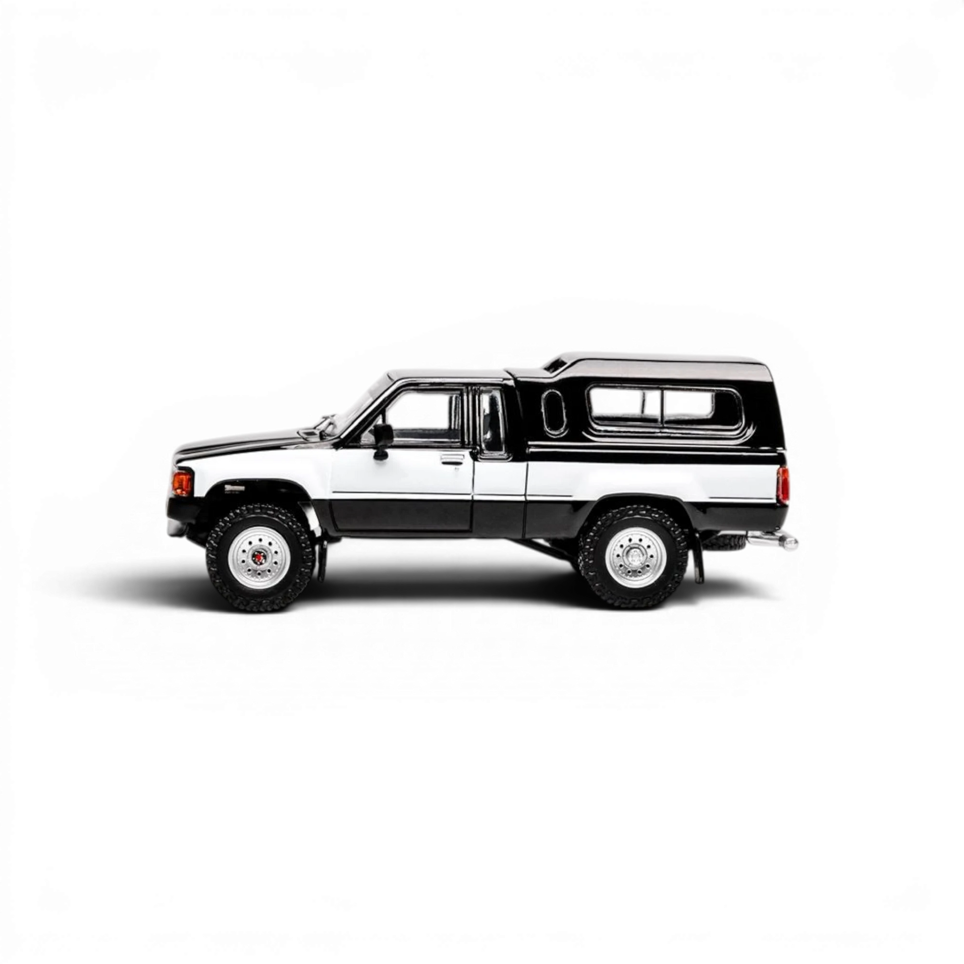 Lot57Supplies Diecast Shop GCD 1:64 scale Toyota Hilux Xtra Cab diecast model truck in black and white side profile view