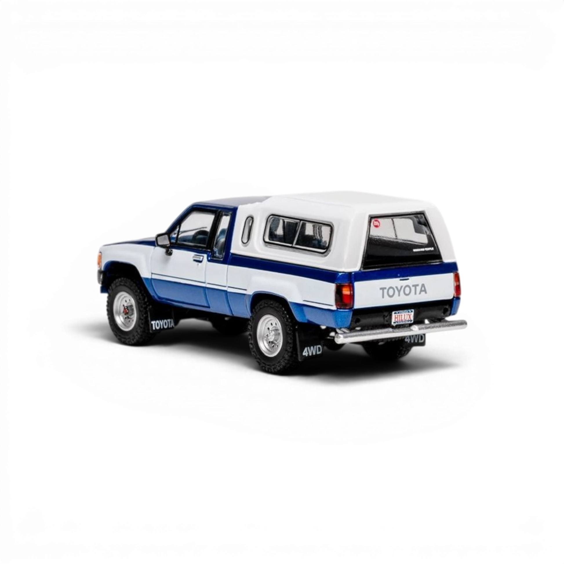 Lot57Supplies Diecast Shop 1:64 scale GCD Toyota Hilux Xtra Cab diecast model truck with blue decals and white canopy