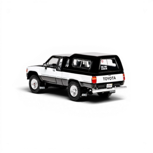 Lot57Supplies Diecast Shop 1:64 scale GCD Toyota Hilux Xtra Cab diecast truck with black decals and camper shell