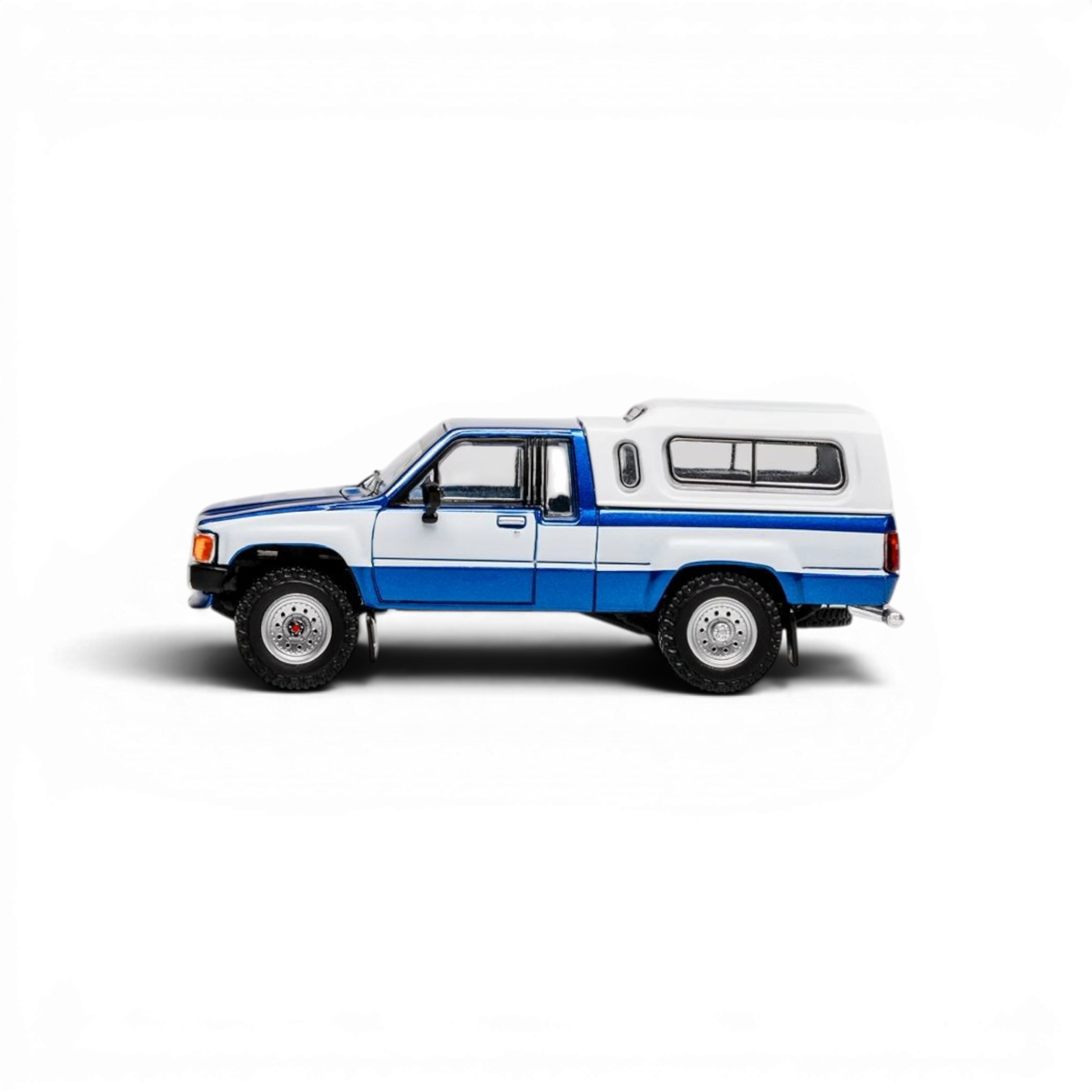 Lot57Supplies Diecast Shop 1:64 scale GCD Toyota Hilux Xtra Cab diecast model with blue and white paint and camper shell