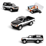 Lot57Supplies Diecast Shop 1:64 scale GCD Toyota Hilux Xtra Cab diecast model truck in black and white with camper shell.