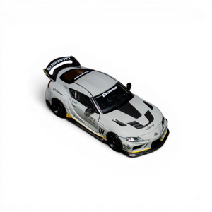 Lot57Supplies Diecast Shop 1:64 scale white Toyota Supra widebody model with carbon fiber accents and yellow trim.