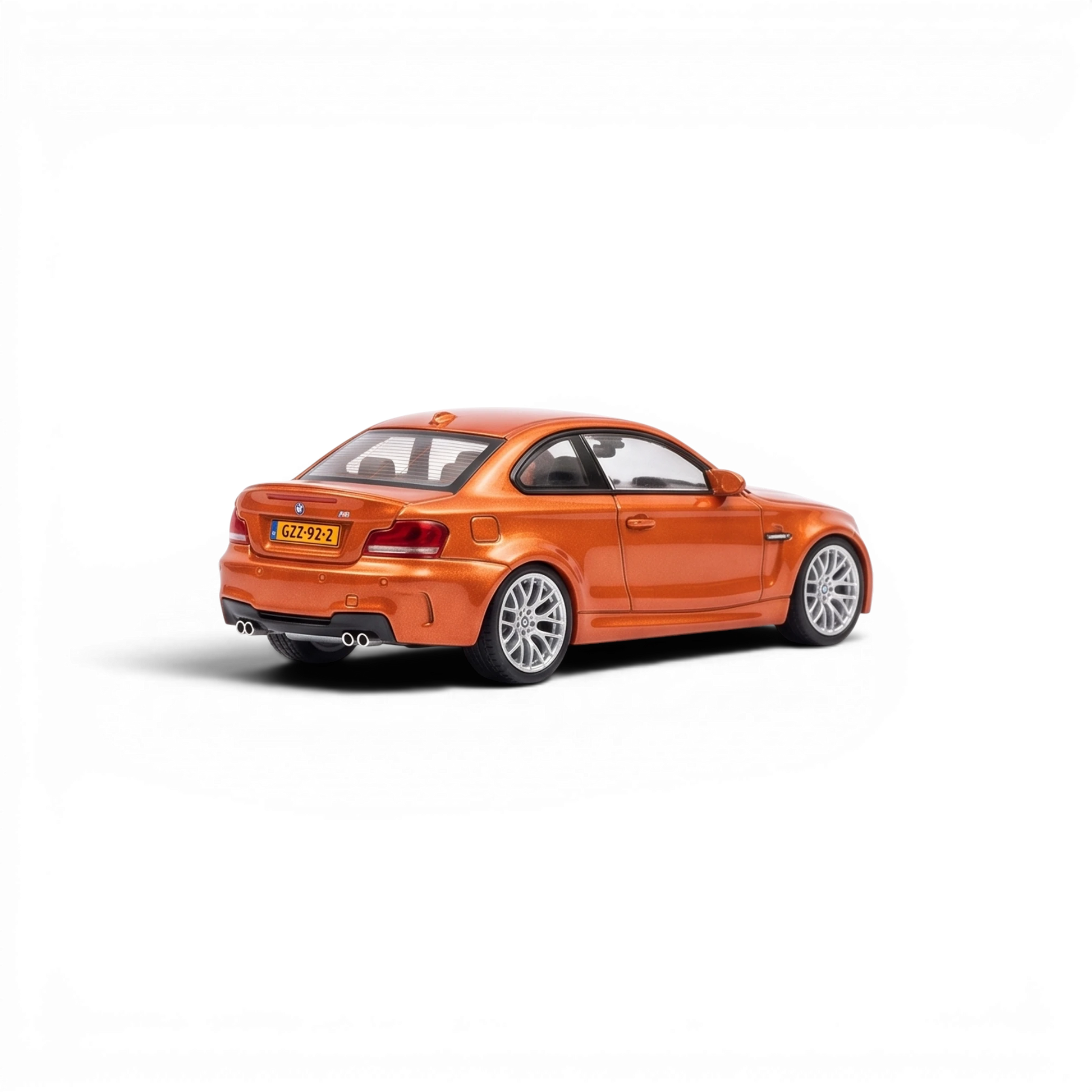 Lot57Supplies Diecast Shop MORTAL 1:64 scale diecast BMW 1M Coupe in Valencia Orange, rear three-quarter view.