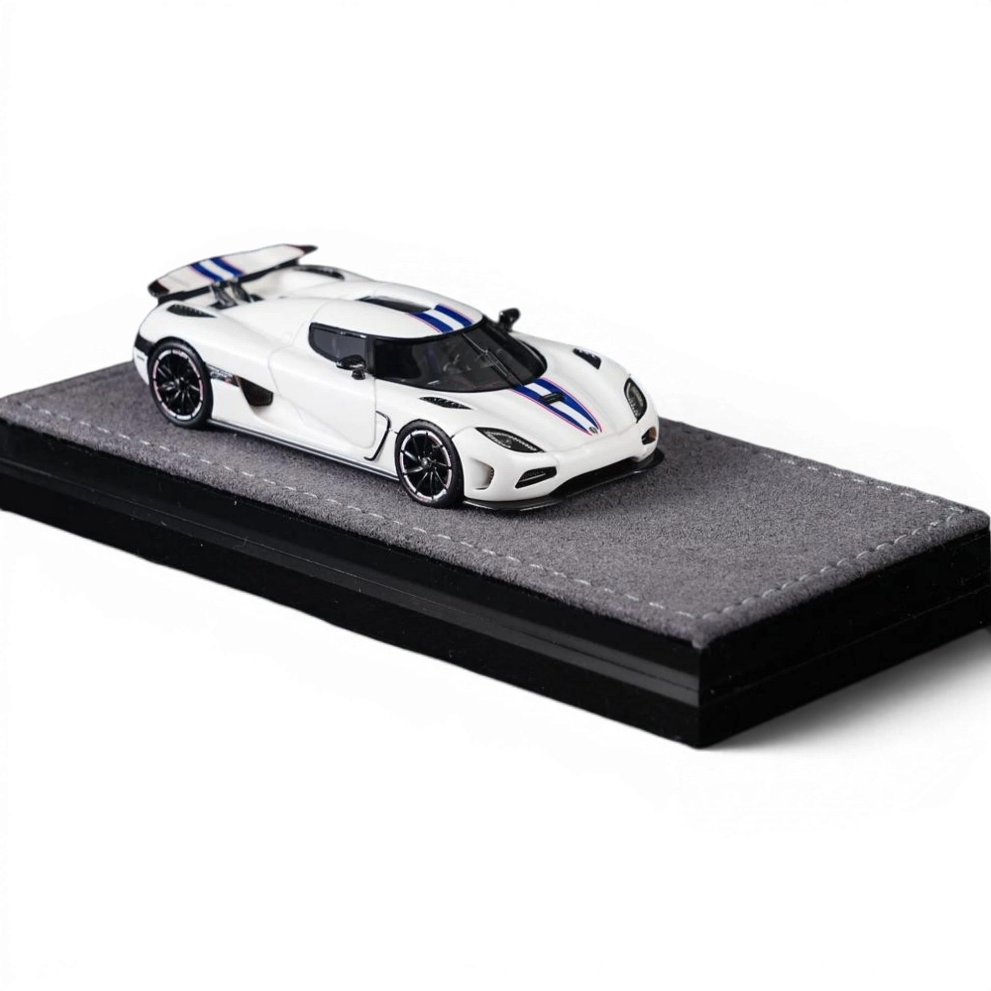 Lot57Supplies Diecast Shop VMB Agera R 1:64 scale white diecast model car with blue racing stripes on a grey display base.
