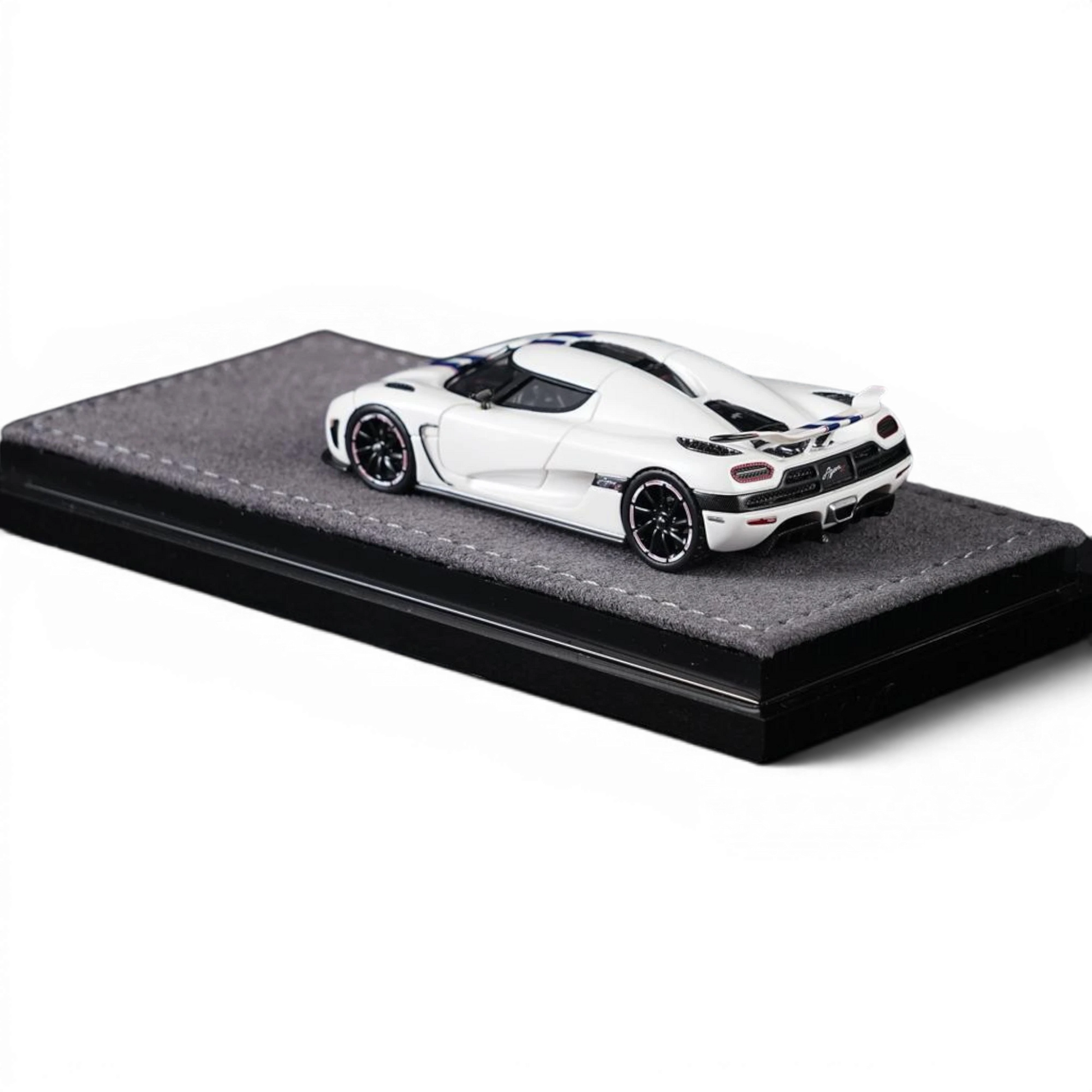 Lot57Supplies Diecast Shop VMB Agera R 1:64 scale white diecast model car with blue racing stripes on a grey display base.