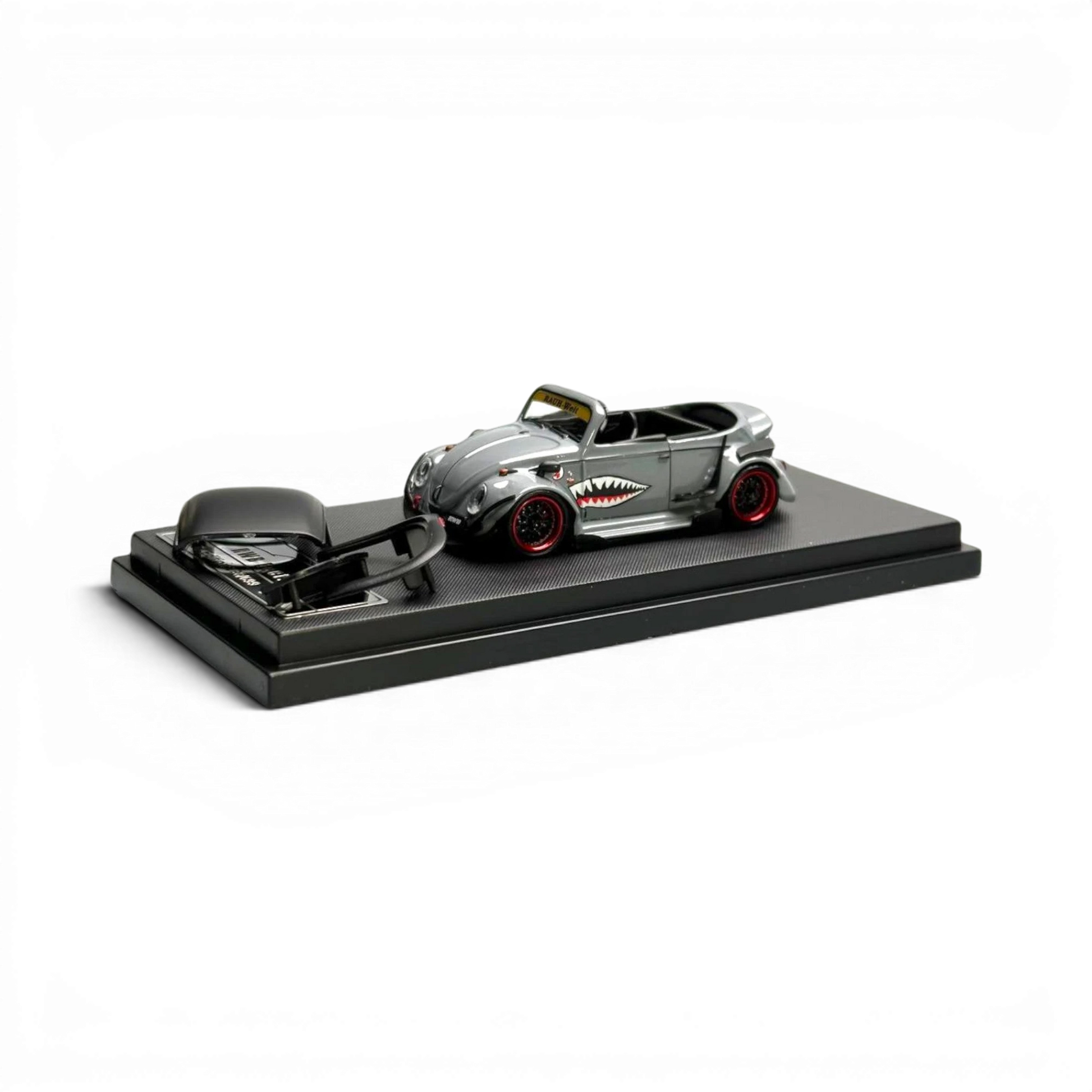 Lot57Supplies Diecast Shop grey VW Beetle convertible 1:64 scale diecast model with shark mouth graphics and red wheels.