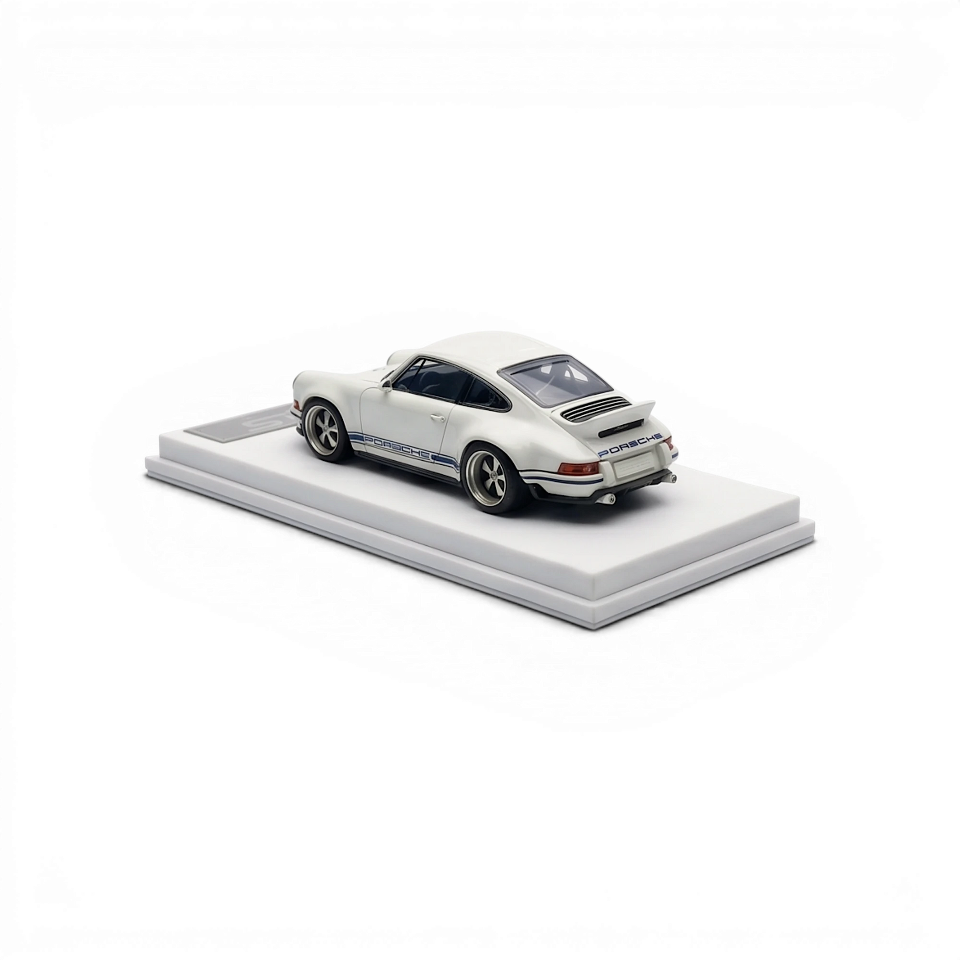 Lot57Supplies Diecast Shop white and dark blue 1:64 scale resin Singer DLS model car with racing stripes on display base.