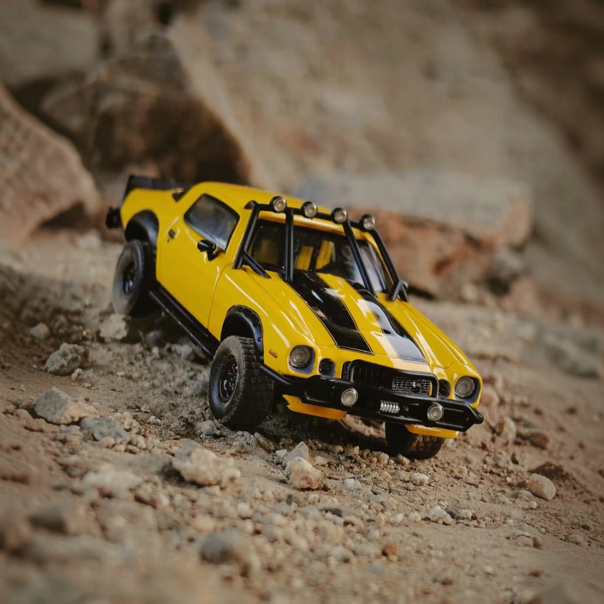 Lot57Supplies Diecast Shop bliss 1:64 scale 1978 Camaro Bumblebee edition diecast car on a rocky off-road terrain