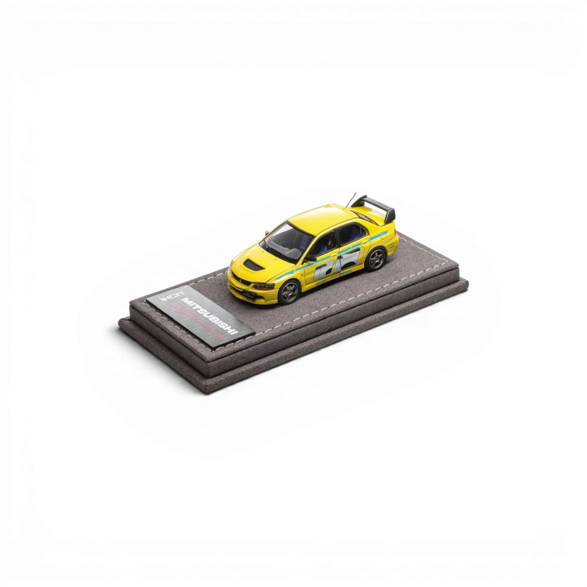 Lot57Supplies Diecast Shop IHCM yellow Mitsubishi Lancer Evolution IX GSR 1:64 scale model on a grey display base.