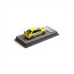 Lot57Supplies Diecast Shop yellow IHCM Mitsubishi Lancer Evolution IX GSR 1:64 scale diecast model car on display base