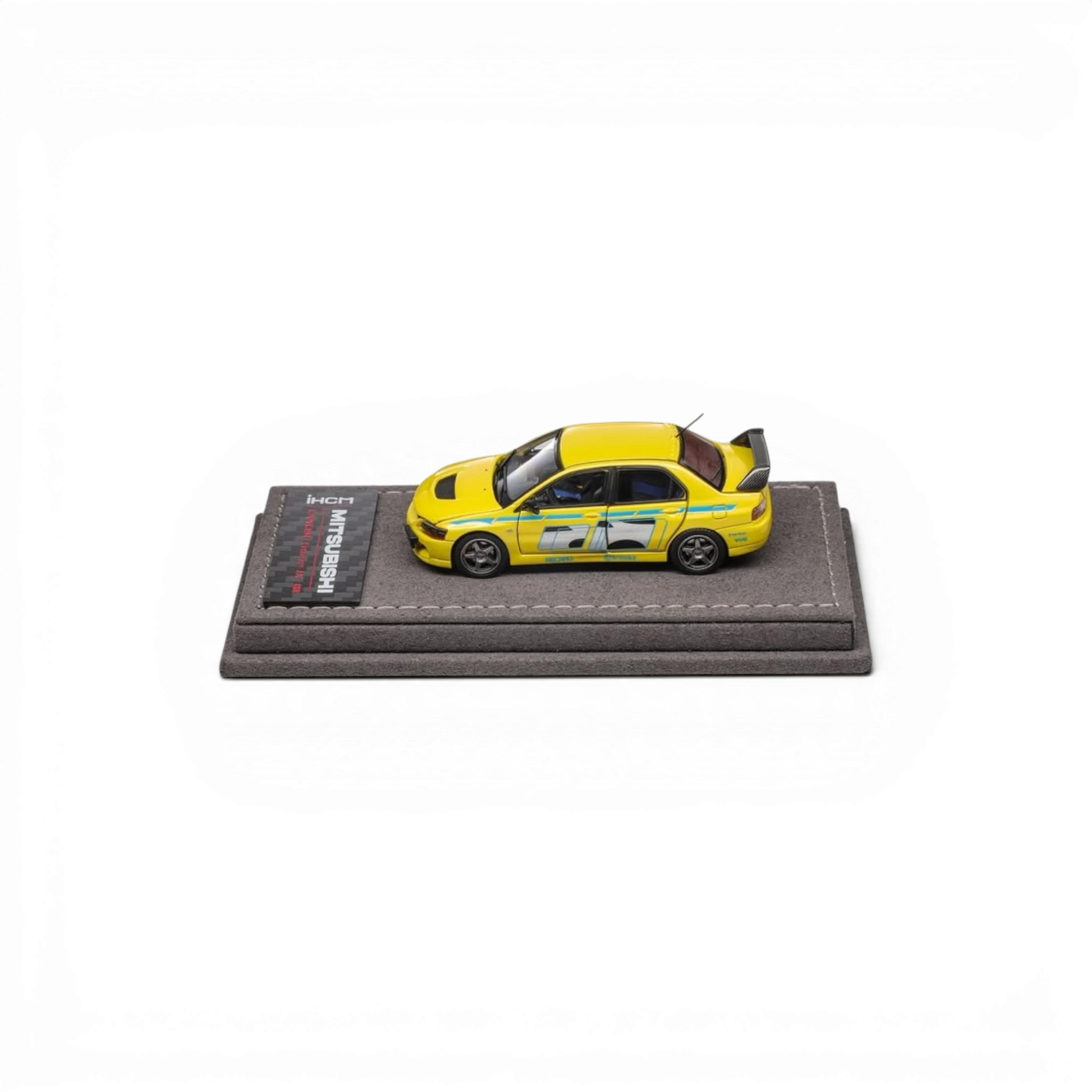 Lot57Supplies Diecast Shop yellow IHCM Mitsubishi Lancer Evolution IX GSR 1:64 scale model on a grey display base.