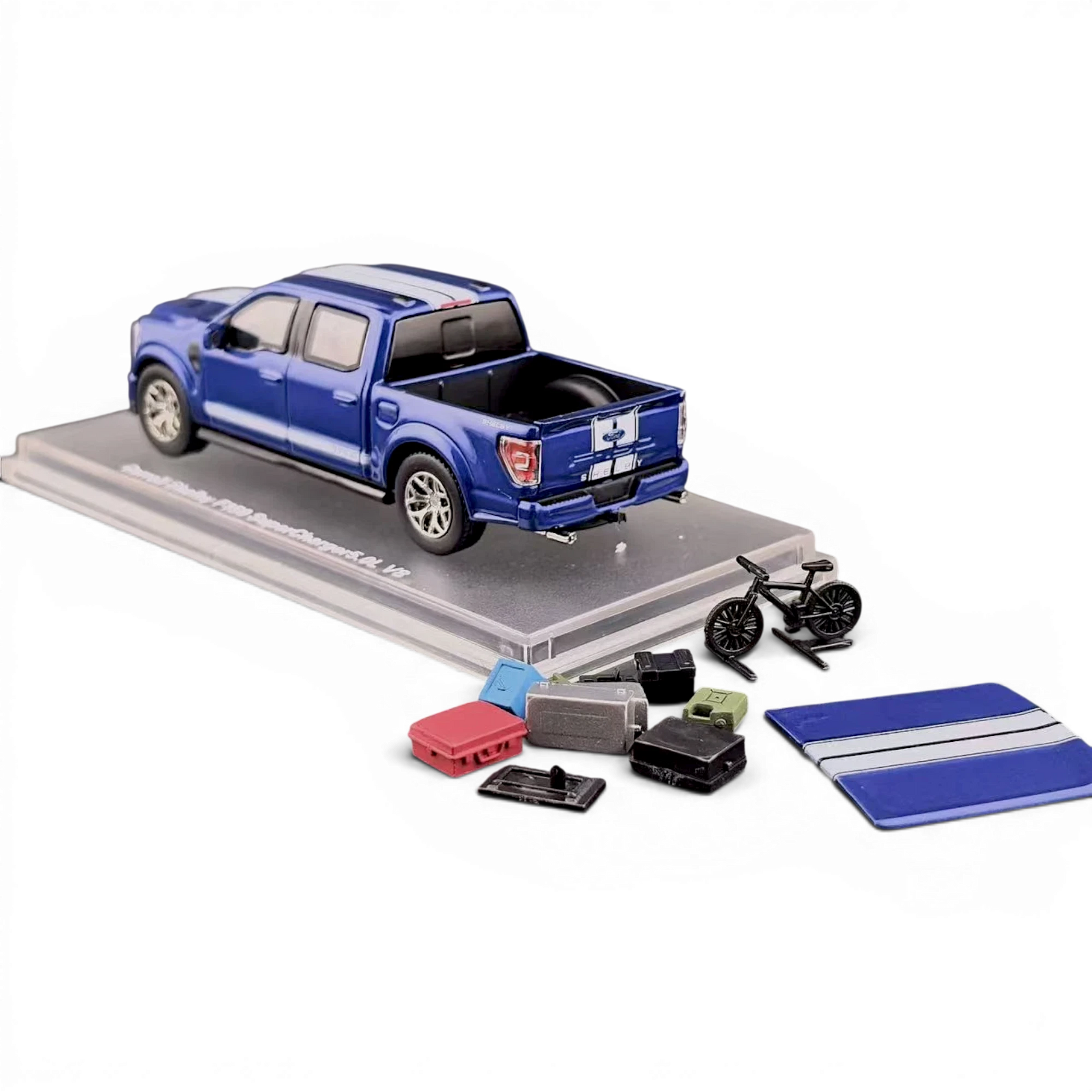 Lot57Supplies Diecast Shop blue 1:64 scale Ford Shelby F-150 pickup truck with white racing stripes, displayed on a clear stand with accessories.