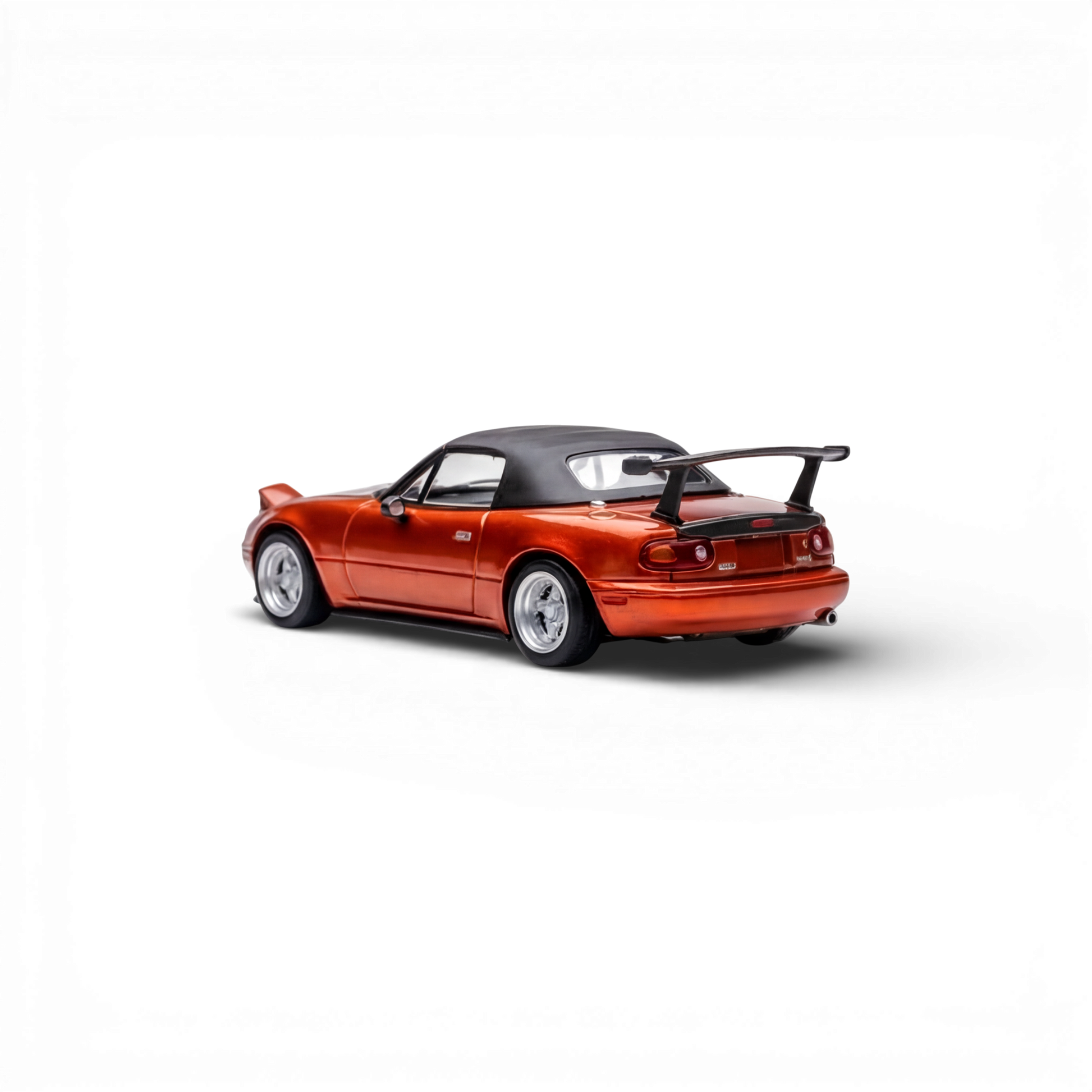 Lot57Supplies diecast model of a red Mazda Miata MX-5 with a black soft top and spoiler. 1:64 scale.