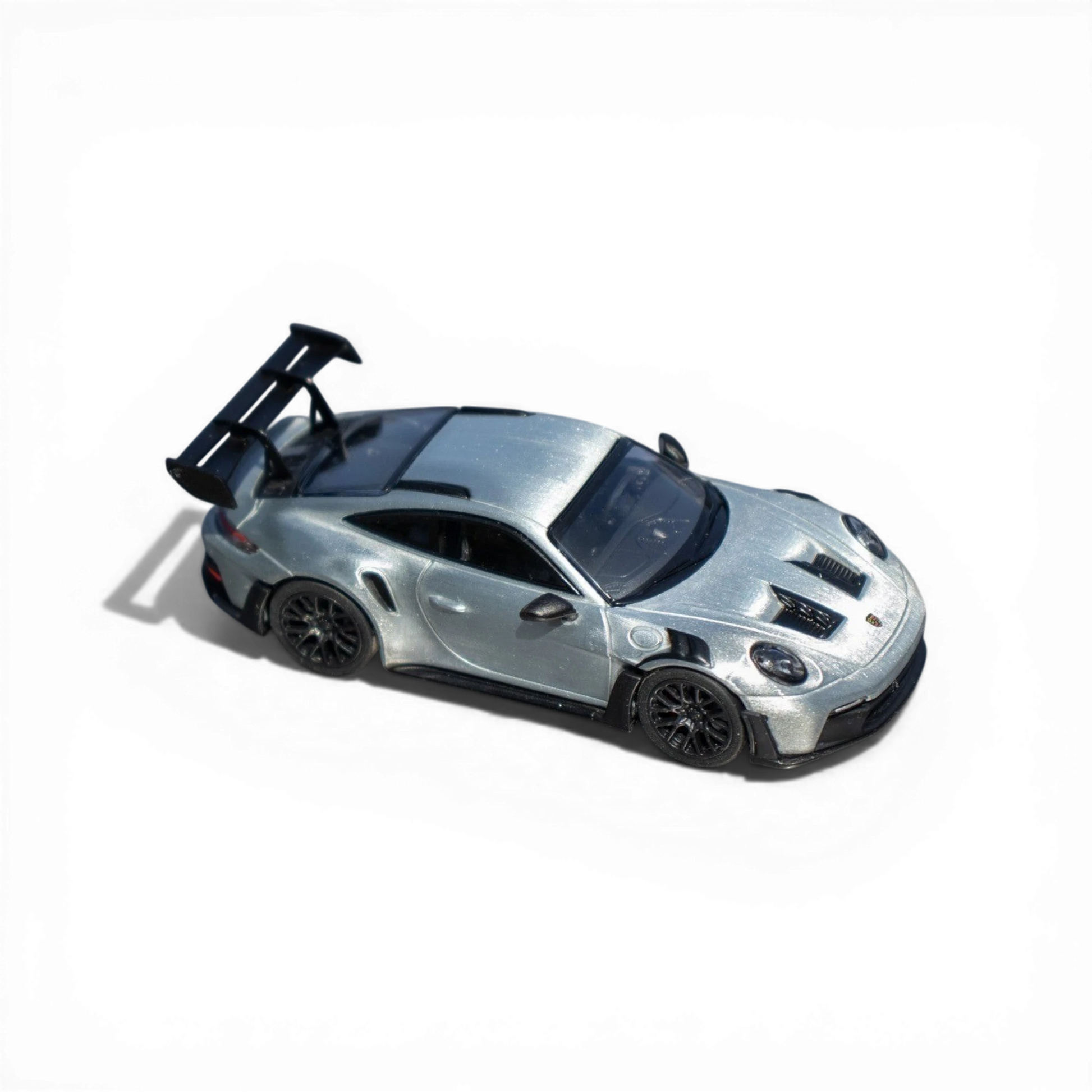 Lot57Supplies Diecast Shop Minichamps Porsche 911 GT3 RS 1:64 scale raw silver diecast model with large rear spoiler.