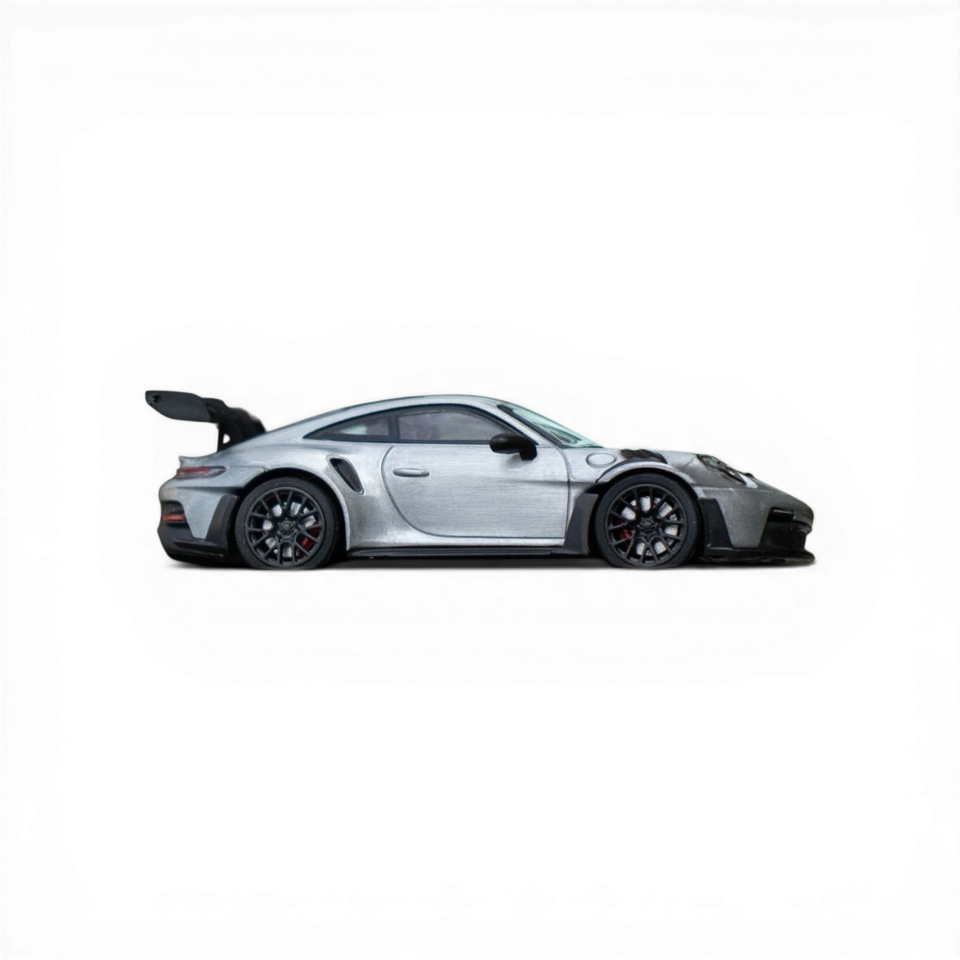 Lot57Supplies Diecast Shop Minichamps Porsche 911 GT3 RS 1:64 scale raw silver diecast model with black accents and spoiler.