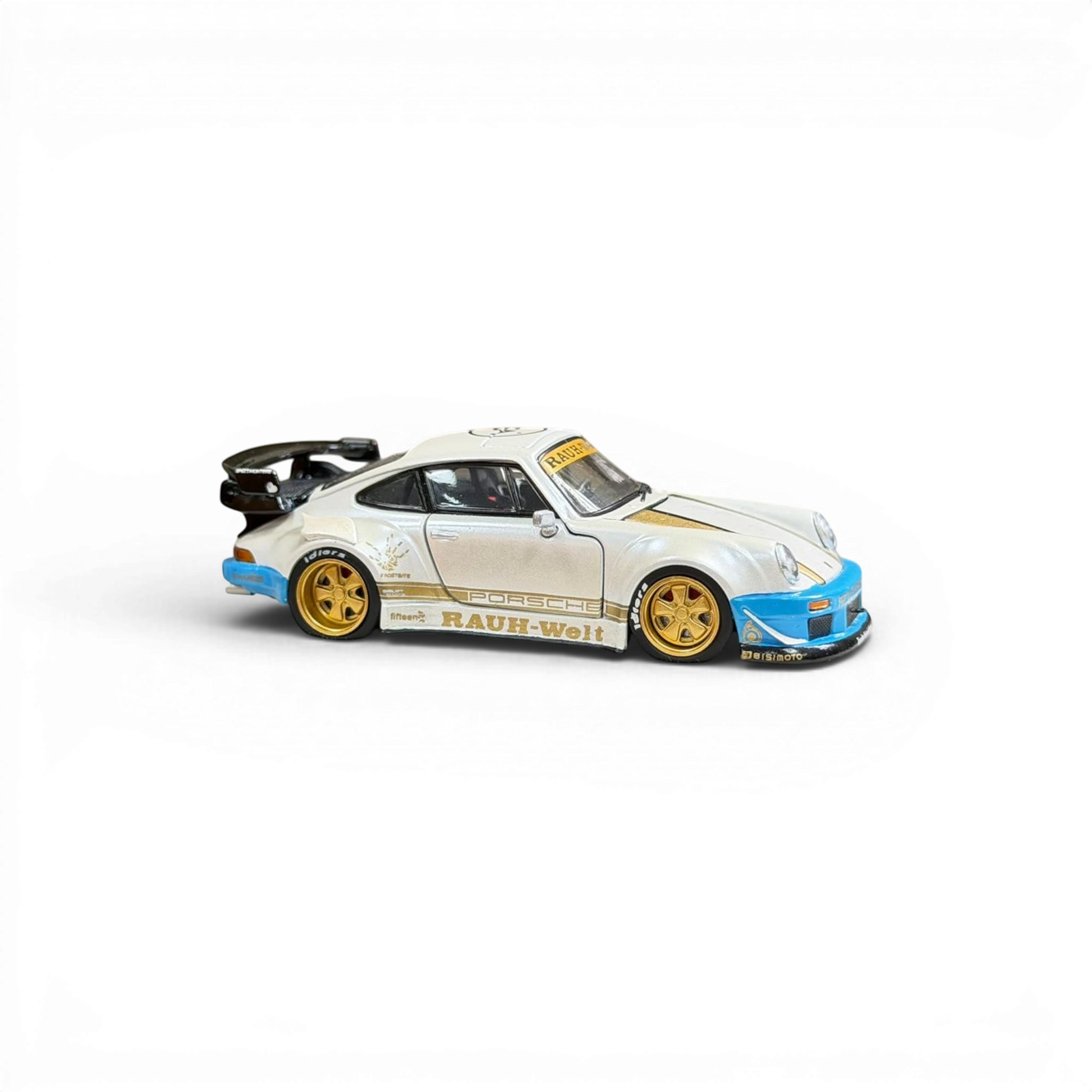 Lot57Supplies Diecast Shop PGM RWB 930 1:64 scale model in matte white with gold and blue accents, featuring a large rear spoiler.
