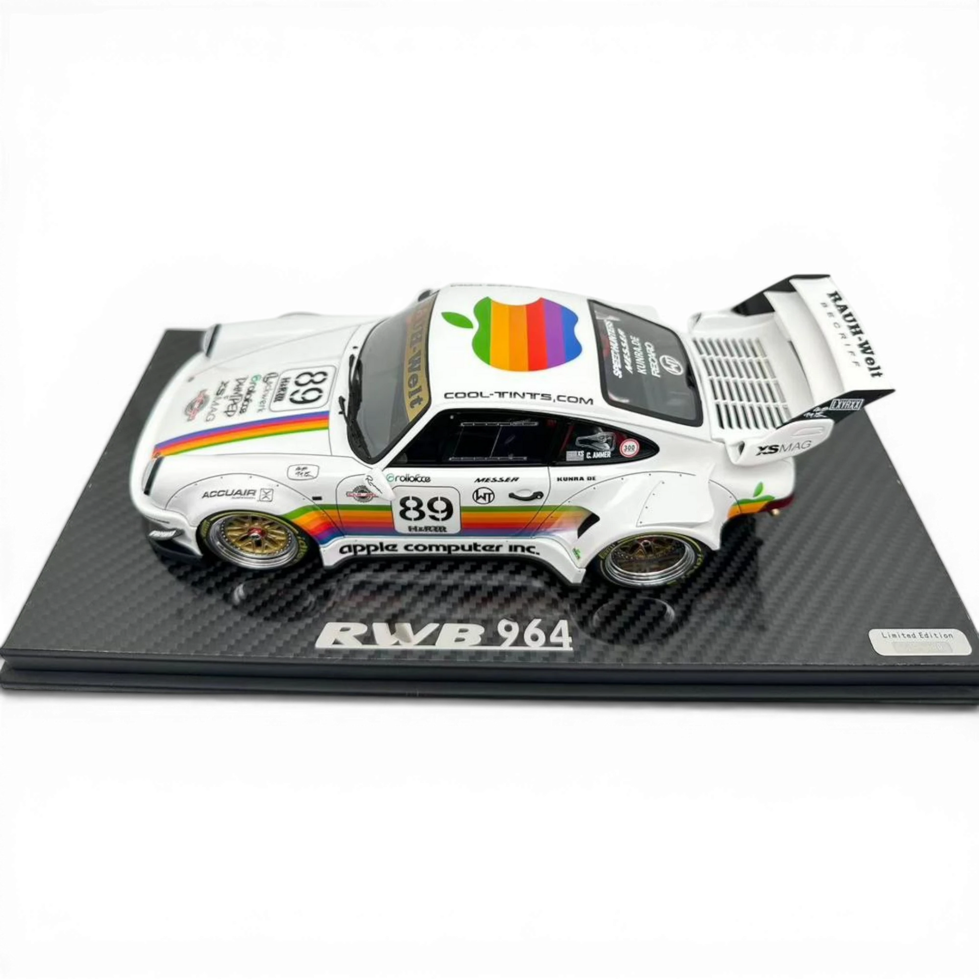 Lot57Supplies Diecast Shop 1:18 scale white Porsche RWB 964 model with Apple Computer livery, rainbow stripes, and gold BBS wheels.